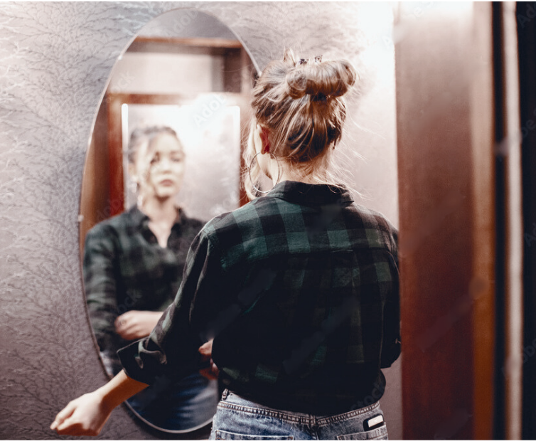 mom appearing burnt out looking in mirror