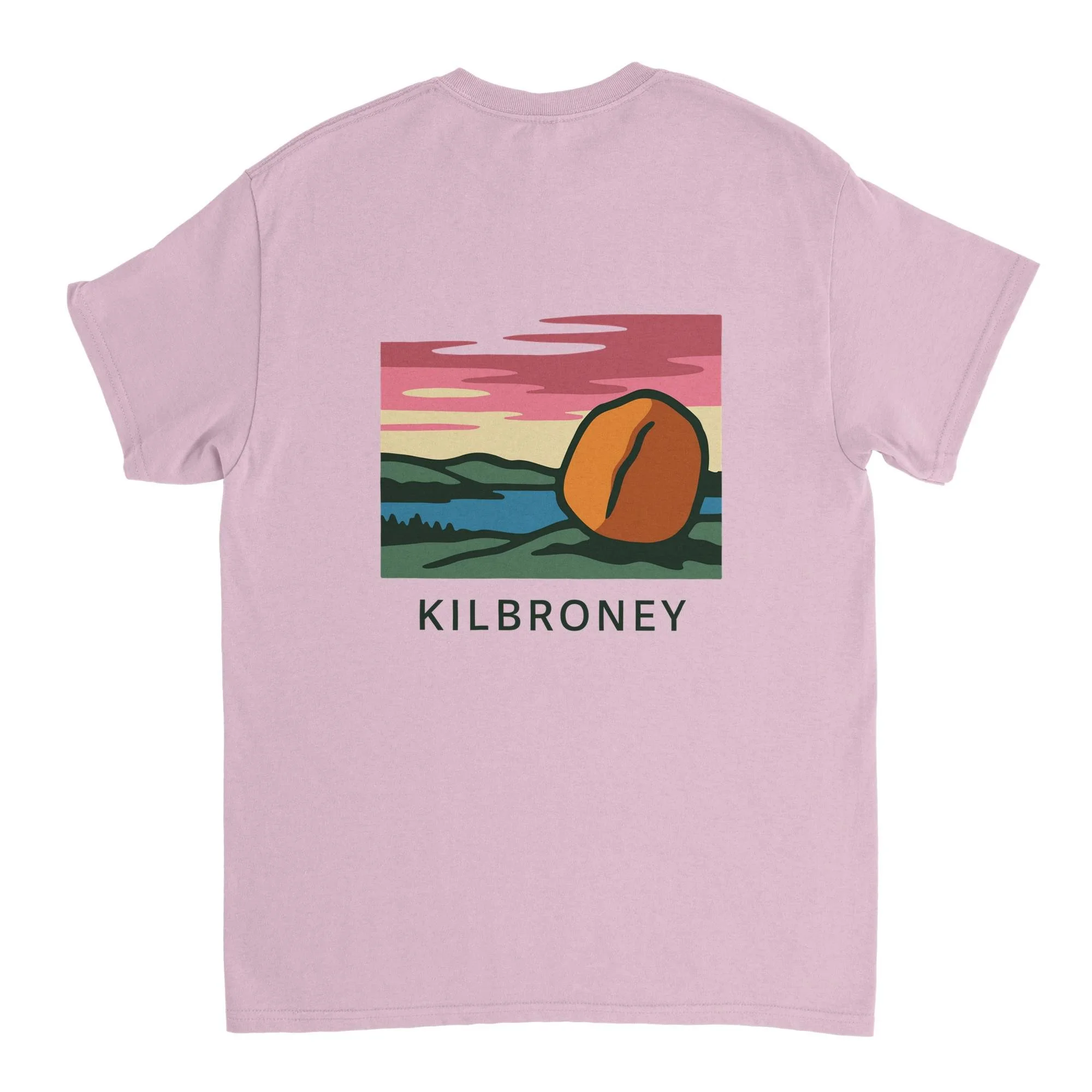 Pink T-shirt with a colorful landscape illustration of hills, water, and sunset clouds, featuring a large coffee bean and the word 'KILBRONEY' beneath it.