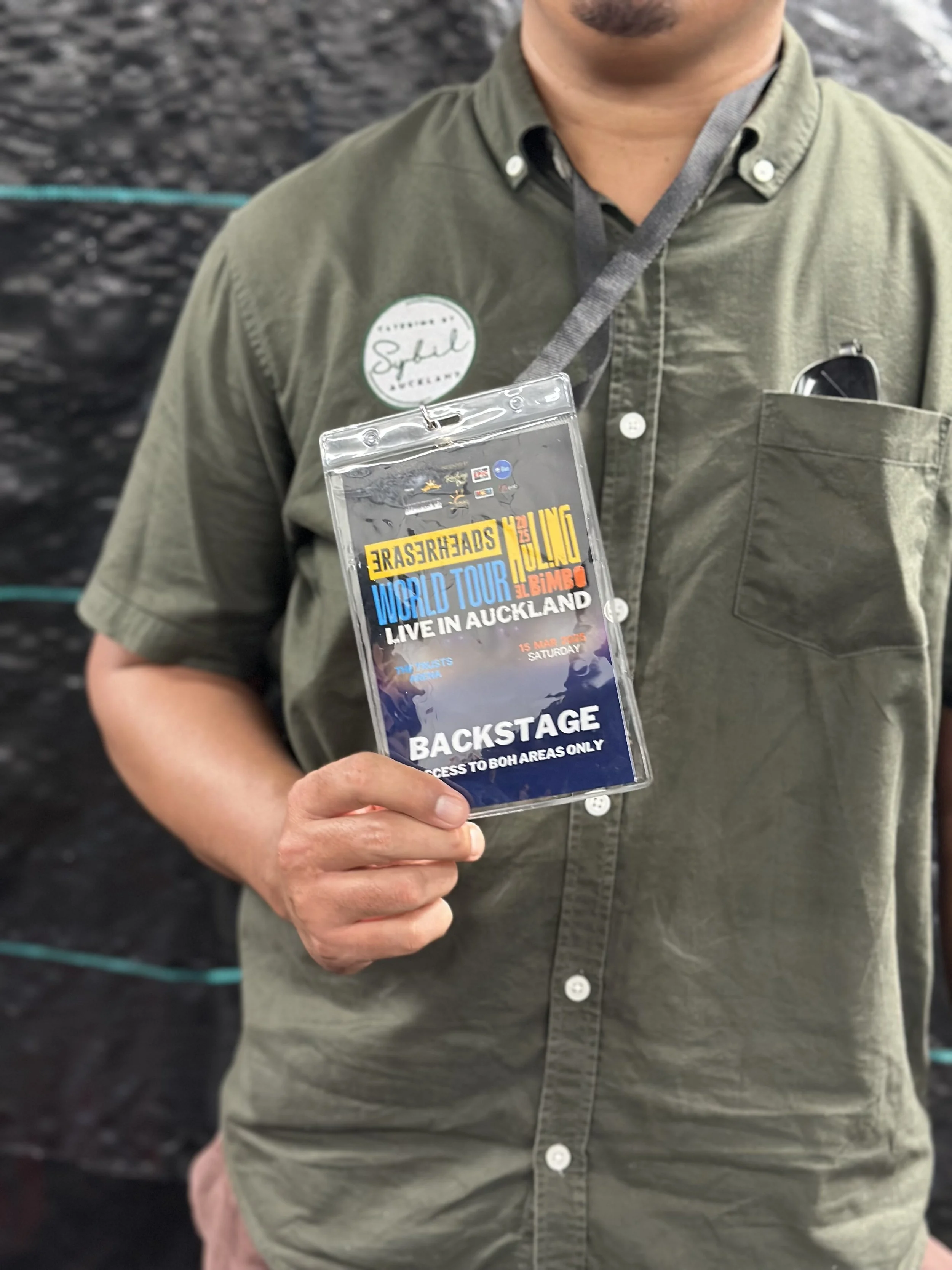 CBS Staff holding a backstage pass for a concert in Auckland, New Zealand.