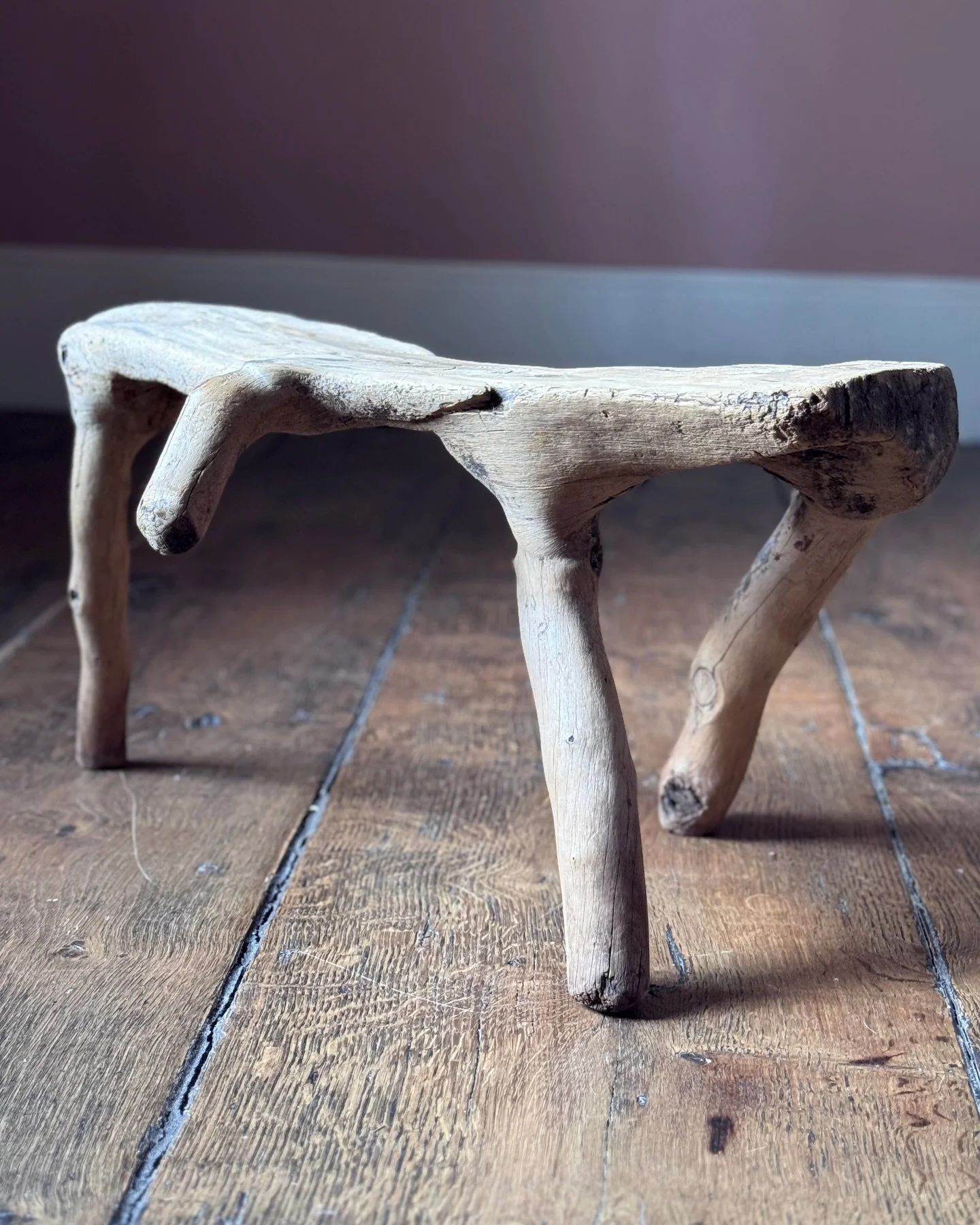 A wonderful three legged 19th Century Swedish milking stool with an extra leg as a handle for carrying. Made entirely from a single piece of wood, this stool looks very much like dog (possibly having a wee). A highly unusual and attractive object.

H