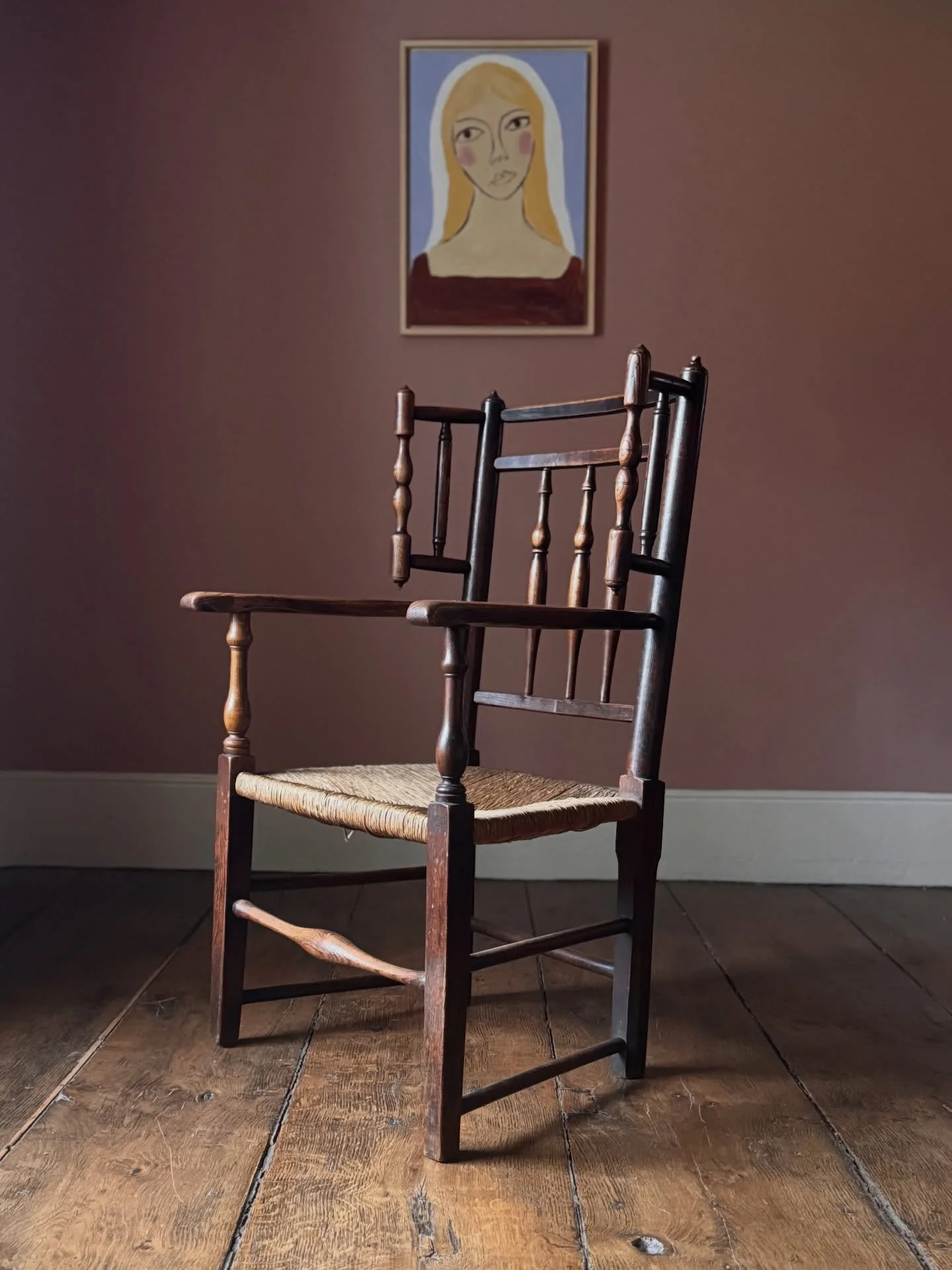 A magnificent Cheshire country armchair that dates to 1800. With it&rsquo;s original rushed seat, this chair has turn out wings which were likely used for a drape to be hung around the person to keep out drafts. A beautifully rich colour and unique s