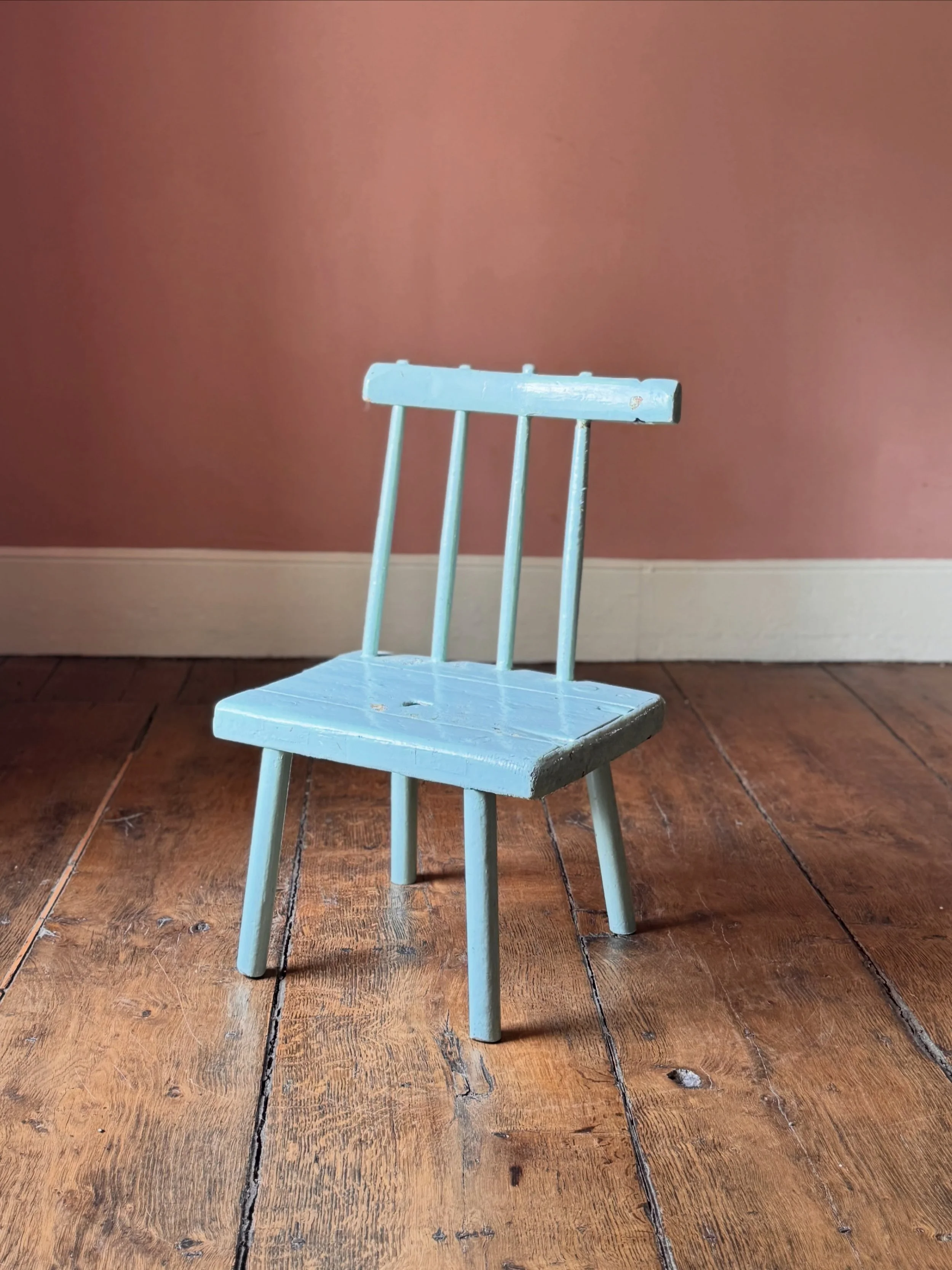 This 19th Century Irish chair from County Antrim has been much loved for over 150 years. Overpainted many times over its life, the current top layer is a beautiful blue with other layers of red and green showing through in places. At some point in th