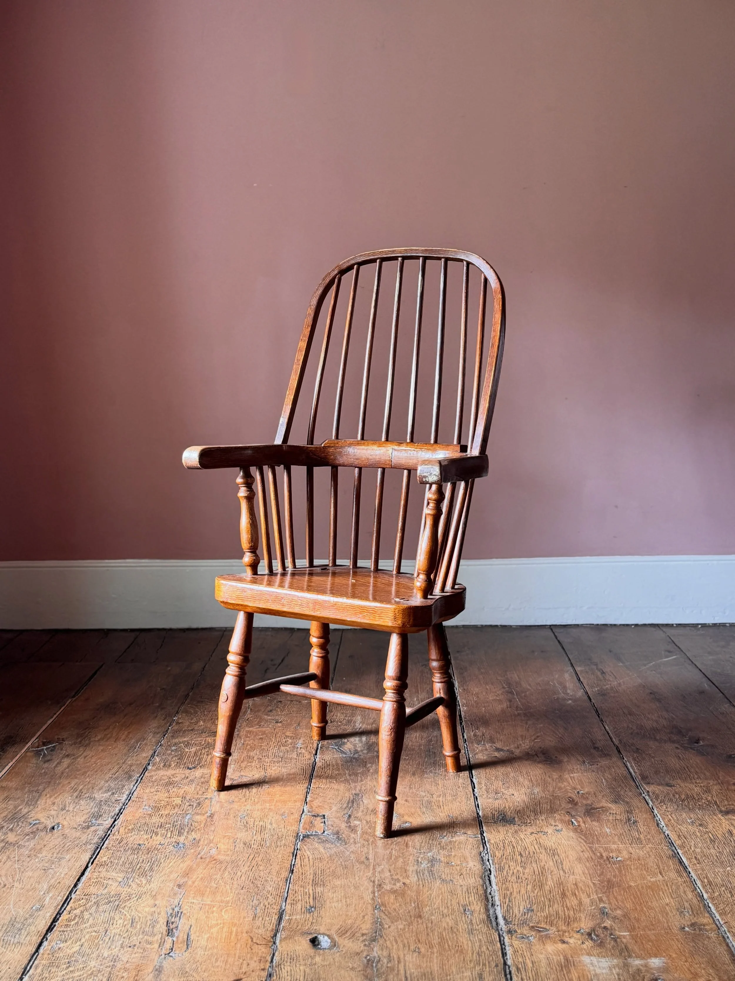 A comfortable 19th Century Welsh stick chair retaining it&rsquo;s original scumble paint finish. Scumbling was the practice of applying a painted finish to furniture to replicate a more expensive wood, in this case oak. Not often seen on chairs. Sour