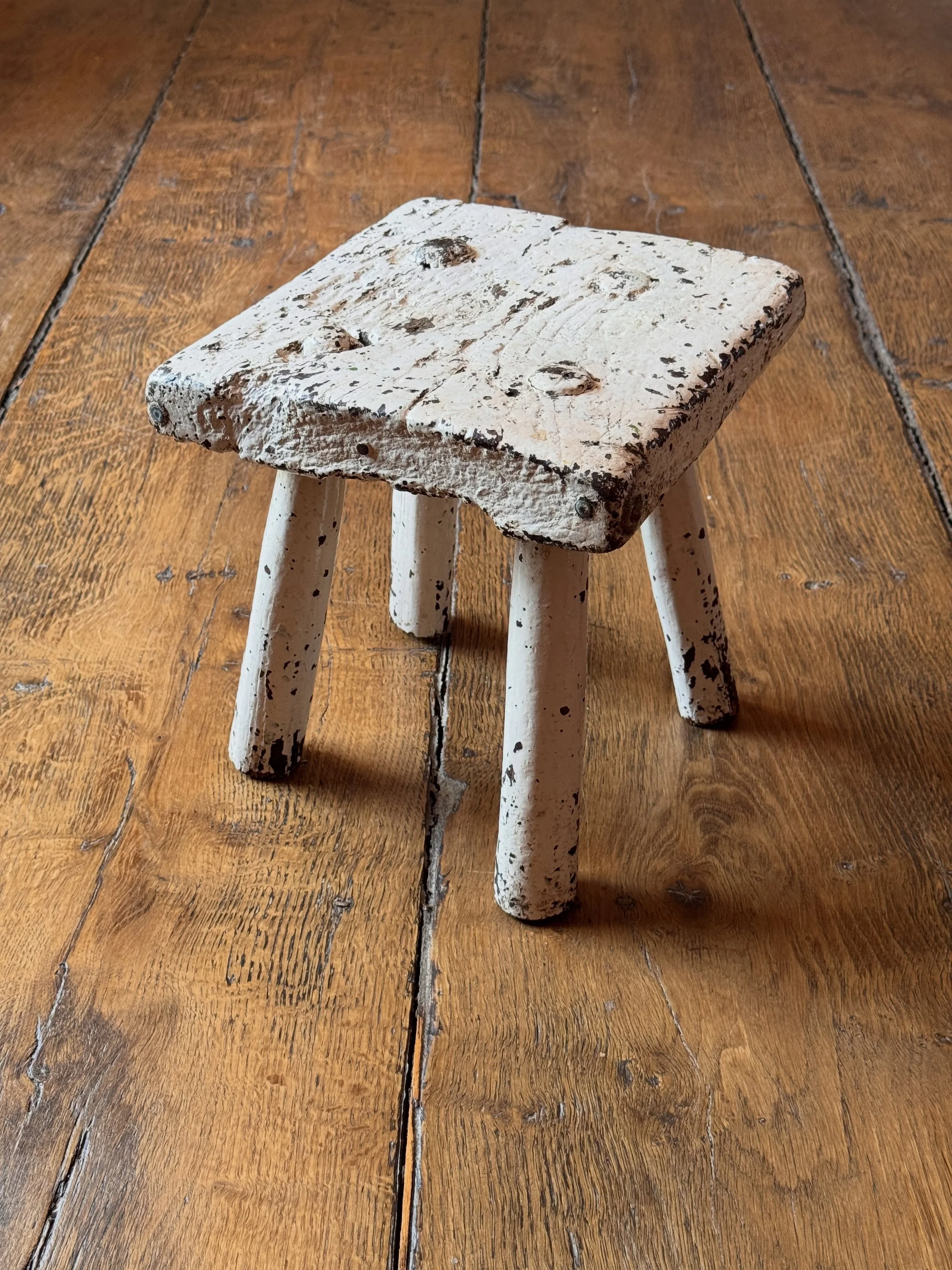 A lovely 19th Century milking stool with a thick slab top over turned legs..Overpainted in historic white paint. A solid, stable and appealing object. Tons of character.

Height 28 cm
Width 26 cm
Depth 25 cm
&pound;195

Now available to purchase on t