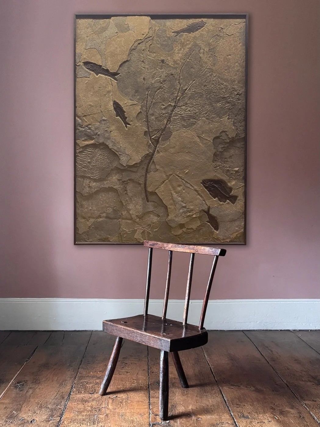 Fossilised fish plates are like a photograph of the earth&rsquo;s prehistoric past. This piece shows various layers and tones of stone, revealing fossil fish and plants which are several million layers apart. Ready to hang in a custom built wooden tr