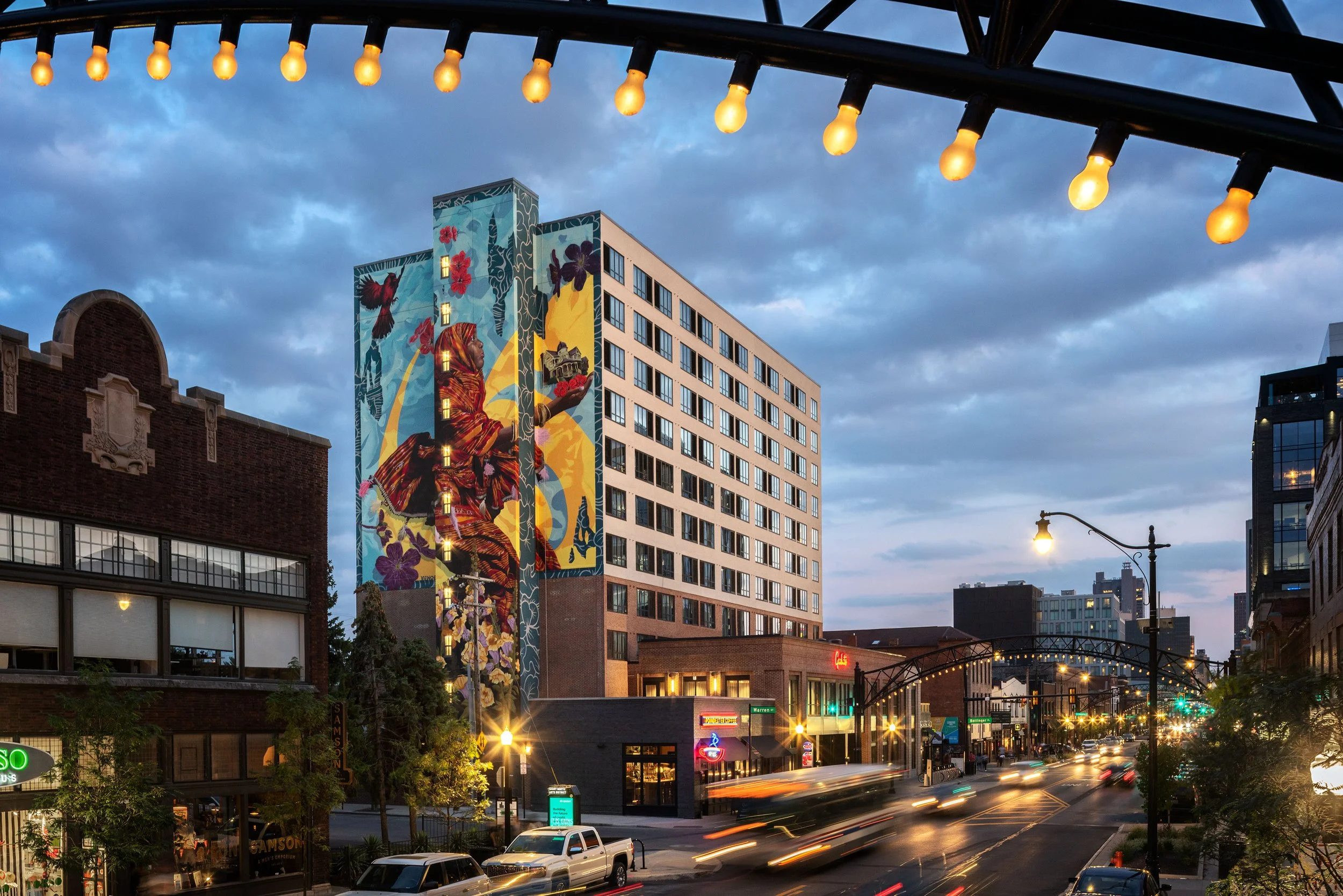 Graduate Hotels by Hilton, Columbus, OH, featuring mural art:  "The Journey", A Somali immigrant story by Hoden Mohammed; Artists:  Ryan Sarfarti and Eric Skotnes / 