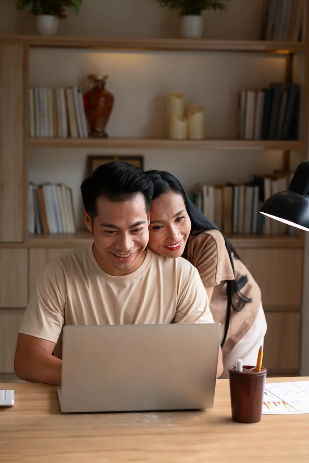 Couple engaging in counseling session with therapeutic office bookshelf background