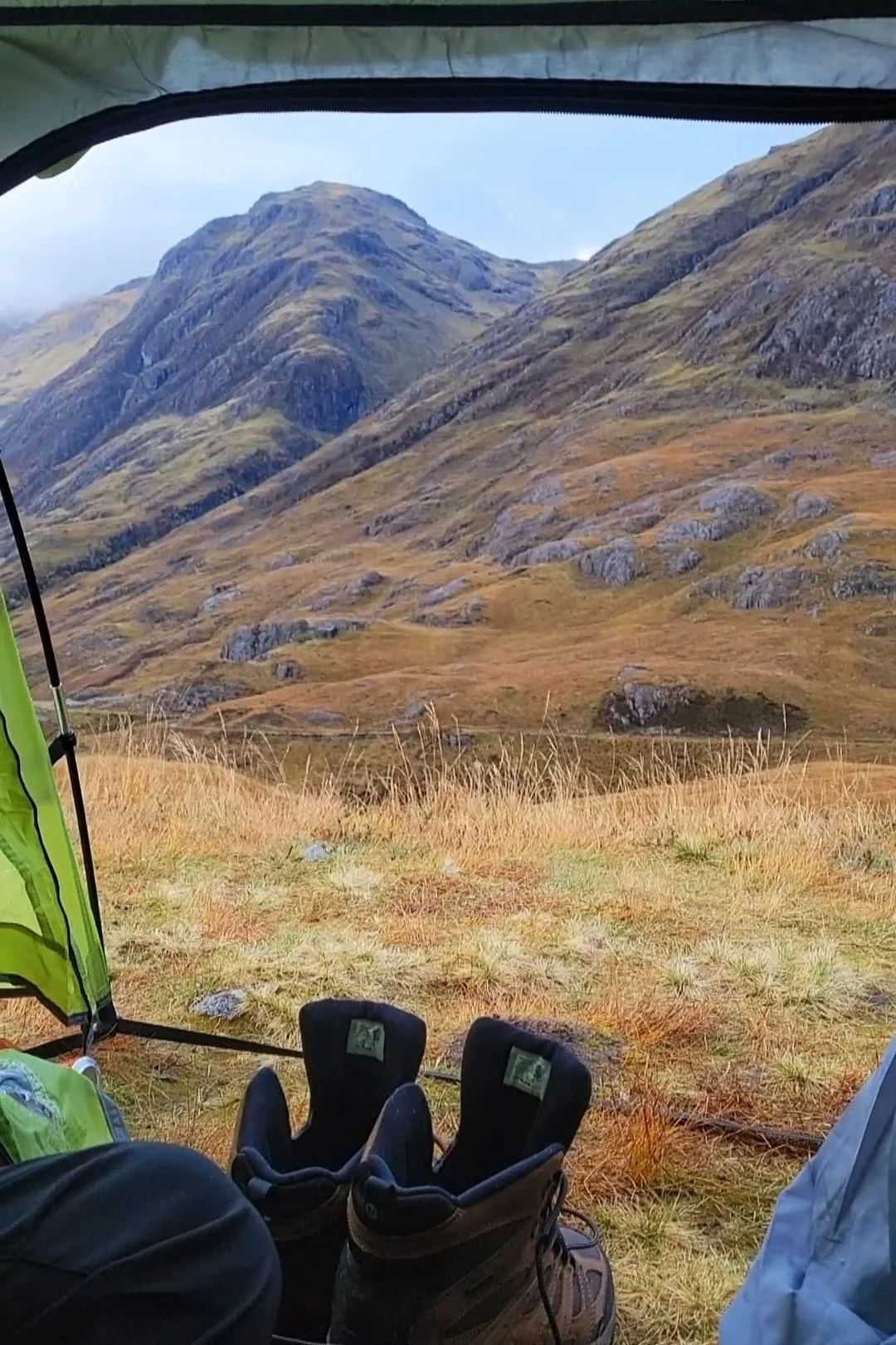 looking out of a tent at the mountains of glencoe