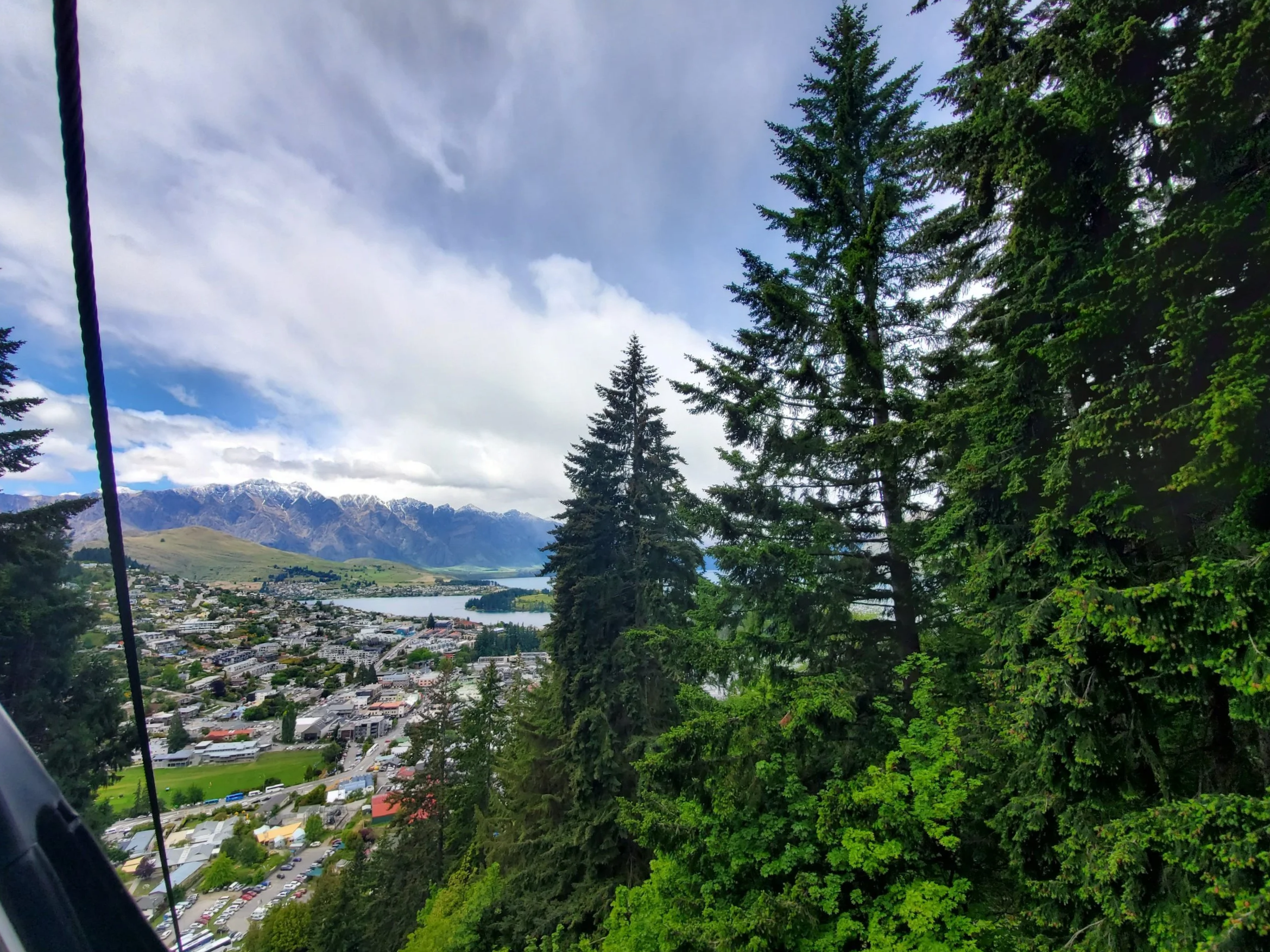 View of queenstown from the skyline gondola going up Ben Lomond. The Remarkables are seen inthe distance