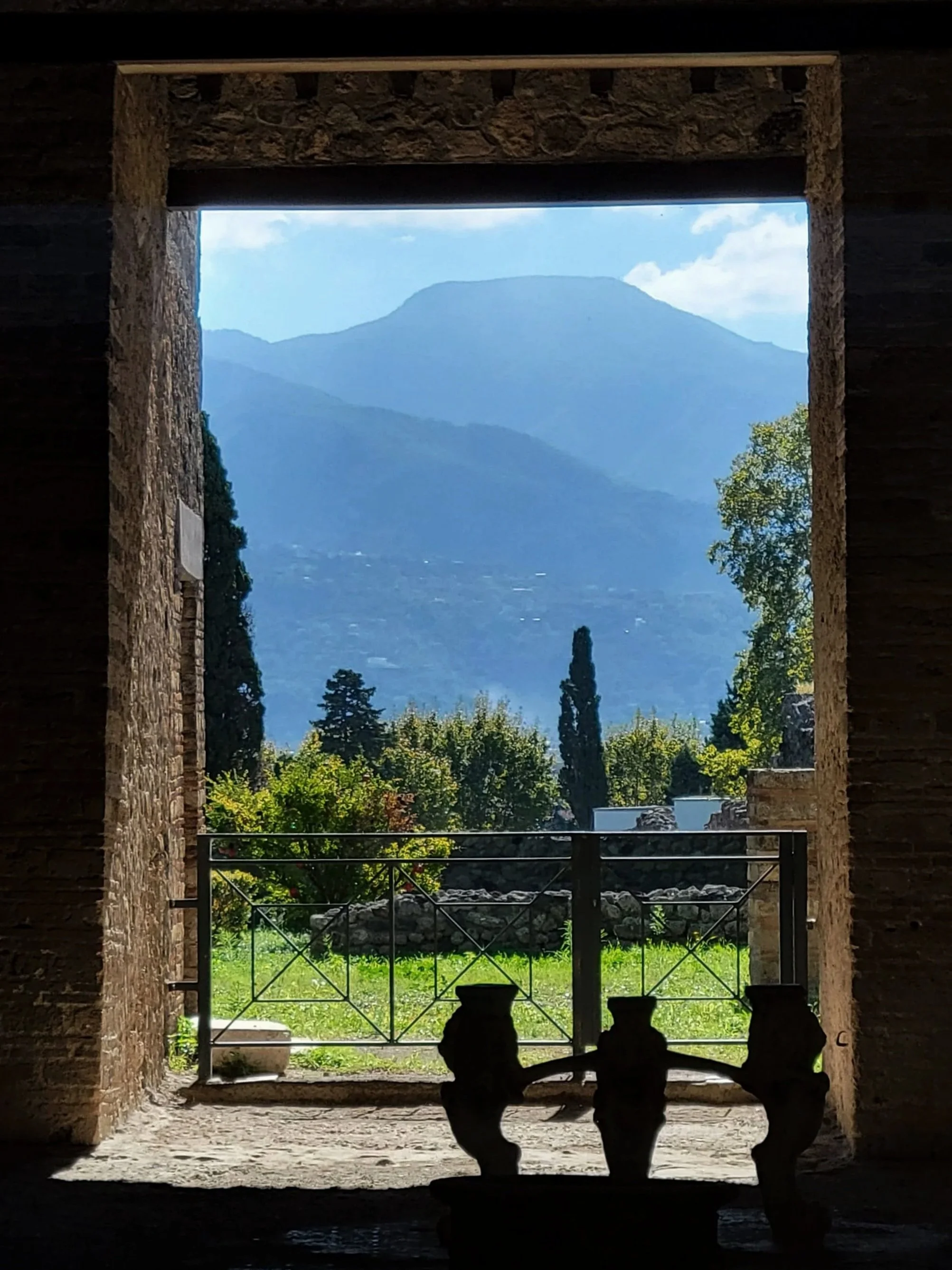 through a window in Pompeii views of the distance mountains