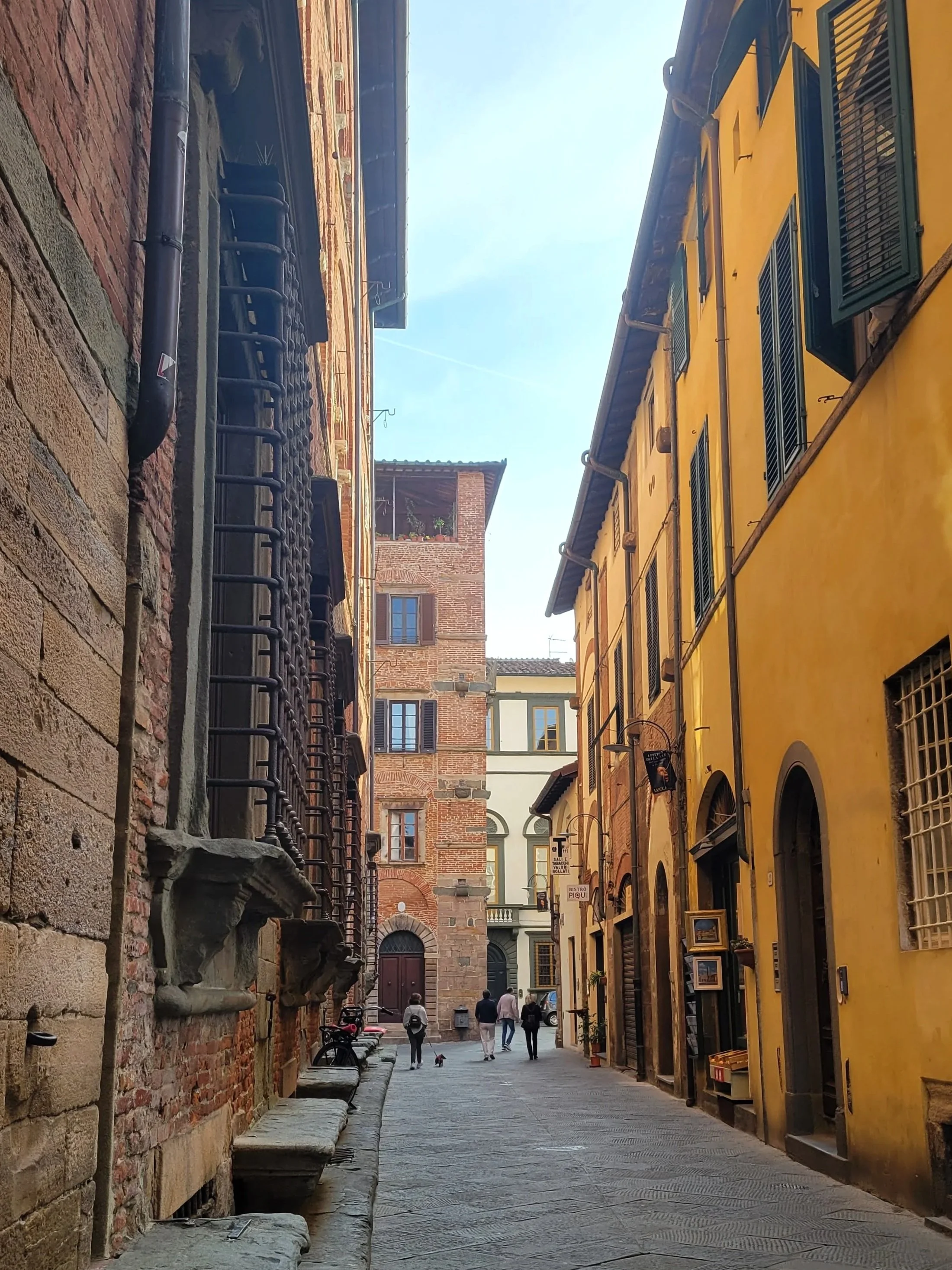 historic streets of Lucca Italy painted in various tones of yellow and red bricks
