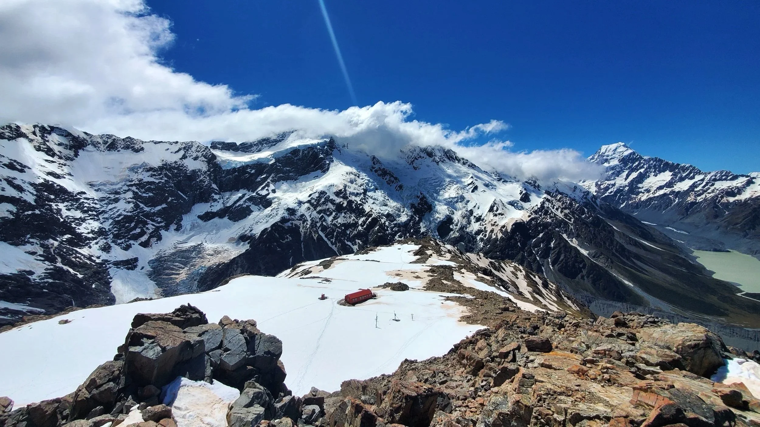 Red Mueller Hut sitting on a snowy summit in Mount Cook National Park New Zealand South Island