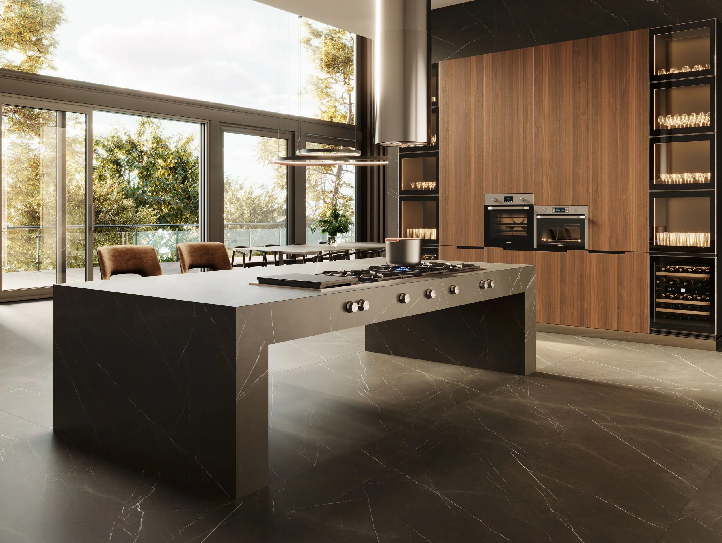 Modern kitchen with black marble island, wooden cabinets, and large glass sliding doors showing an outdoor balcony with trees.