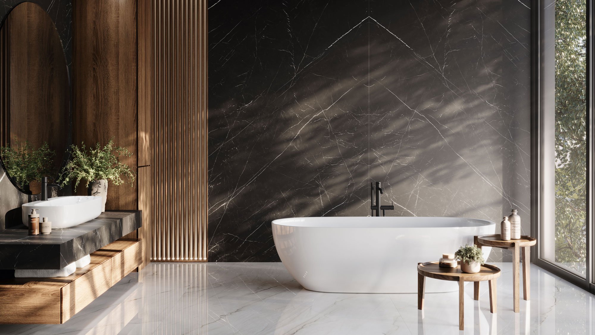 Modern bathroom with a white freestanding bathtub, black wall with marble veins, wooden accents, a black sink with a white vessel, green plants, and tall window with natural light