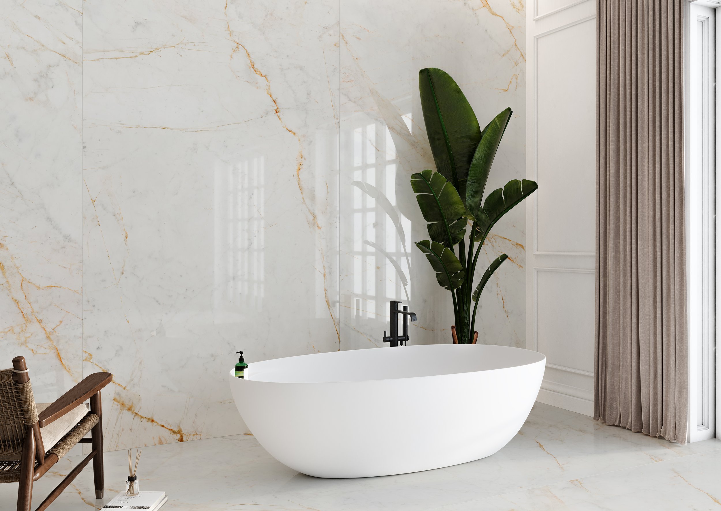 Modern bathroom with a white freestanding bathtub, marble wall, large green plant, and beige curtains.