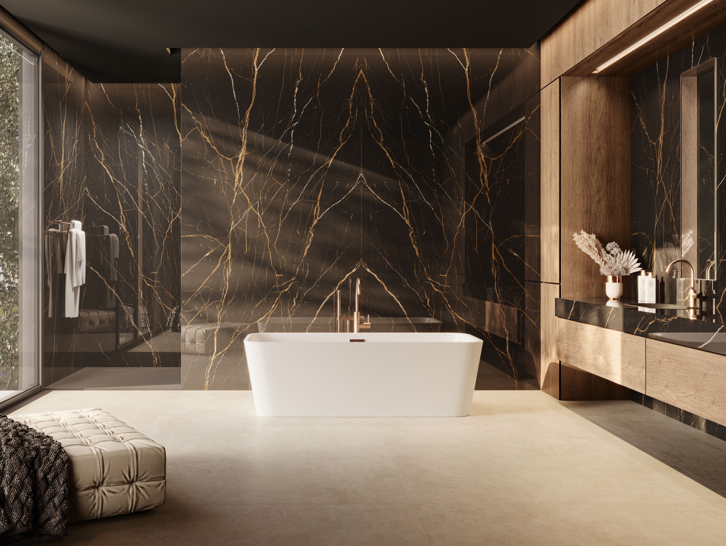 Modern bathroom with a black and gold marble wall, freestanding white bathtub, wooden cabinetry, vase with flowers, and a large window.