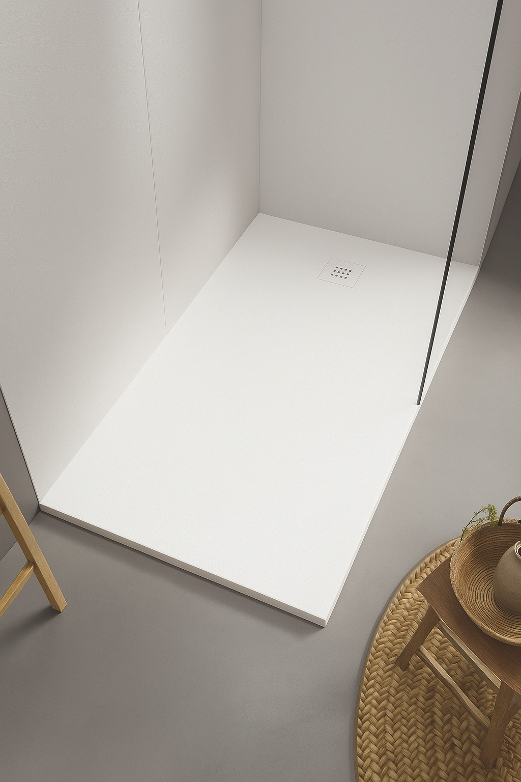 Empty white shower base with drain in a minimalist bathroom corner.