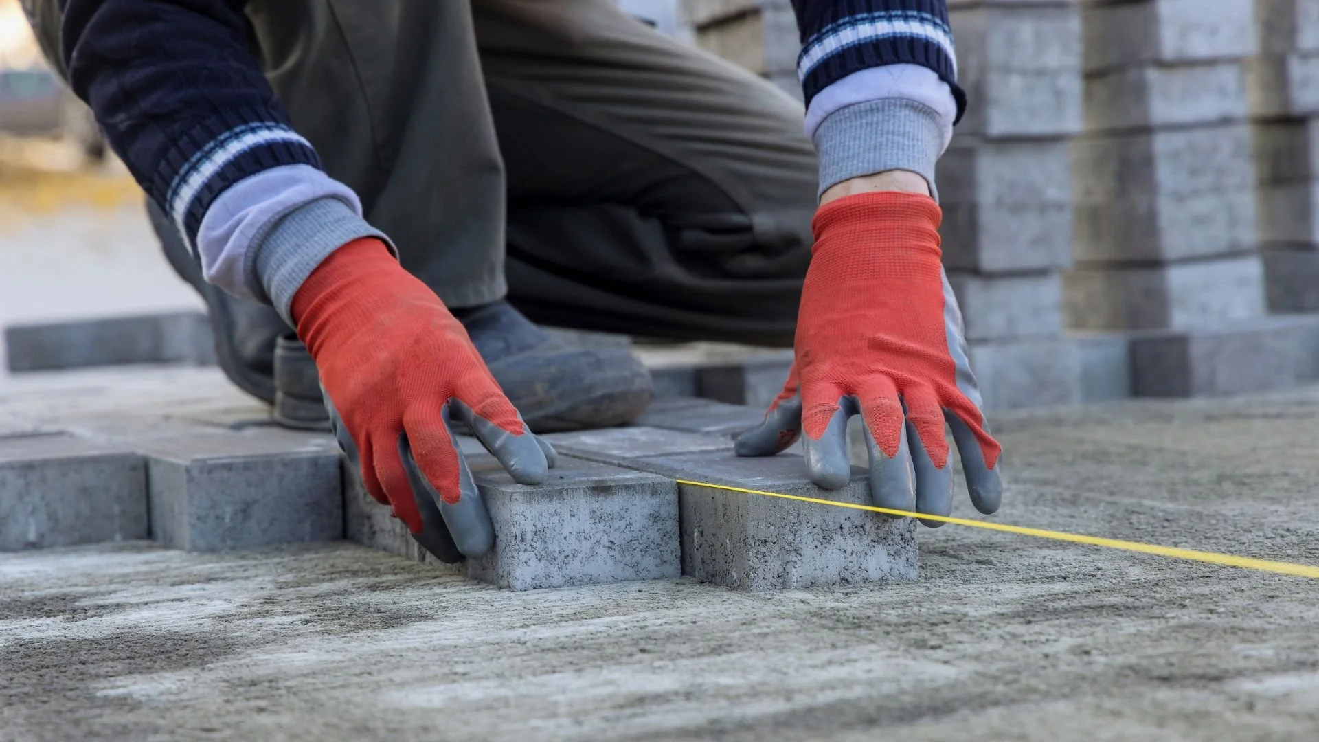 Brick wall with alternating layers of red and gray bricks.