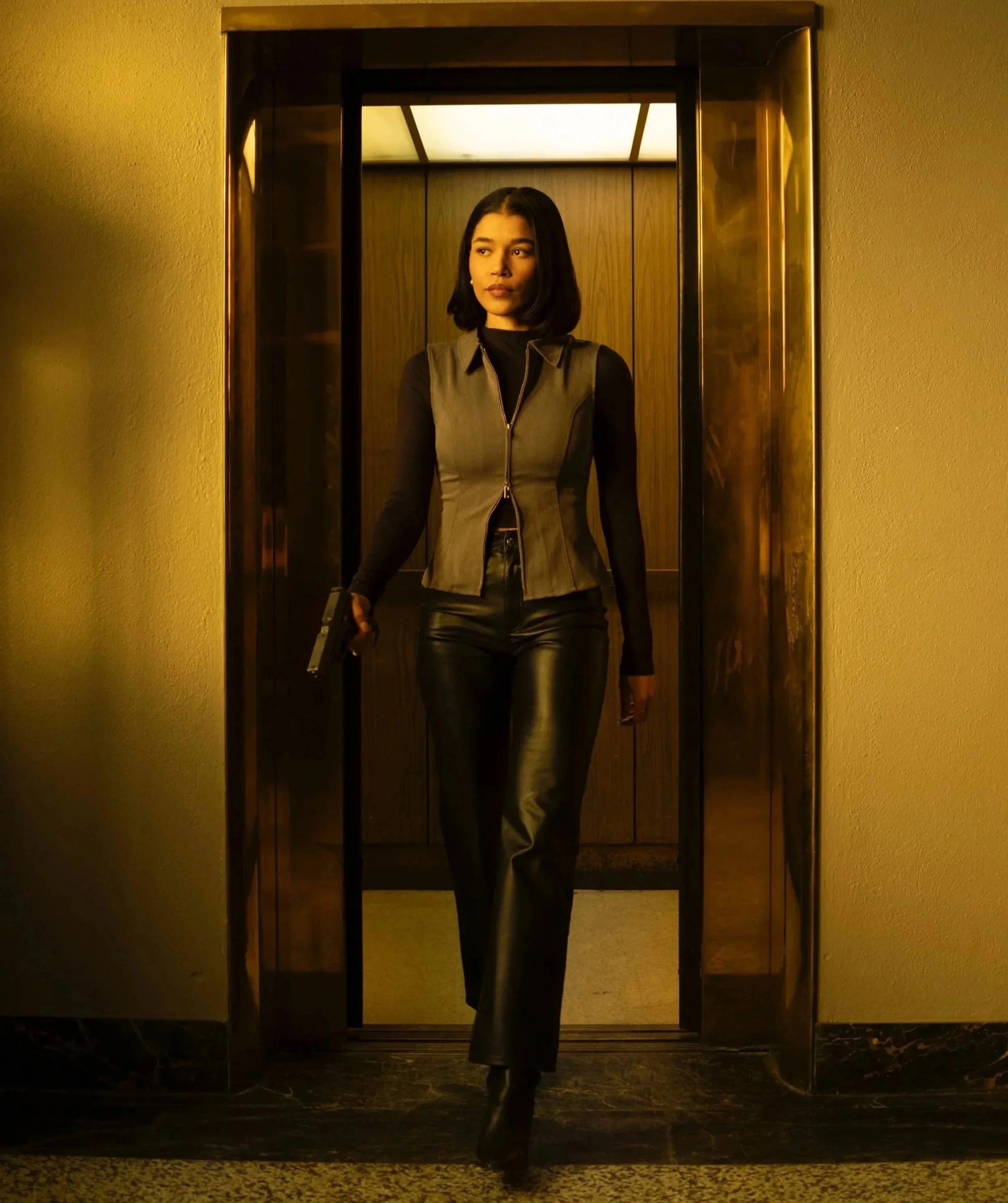 Savannah Bangoura standing in an elevator in a film still.