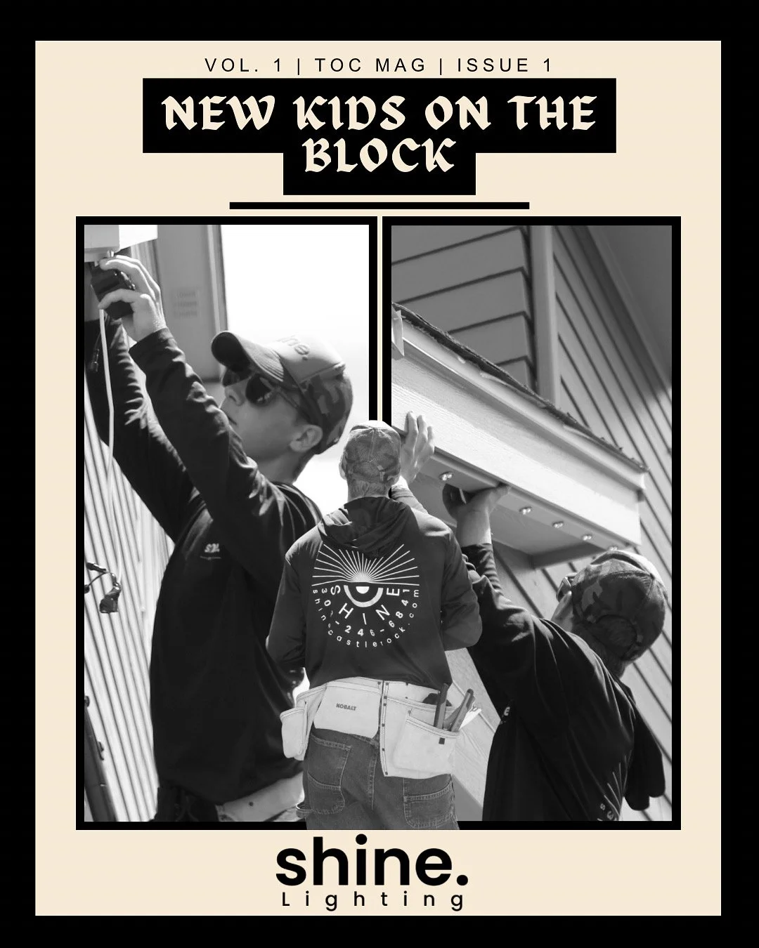 Two workers install exterior lighting on a house, one holding a light fixture and the other holding a ladder, both wearing hats and work attire.