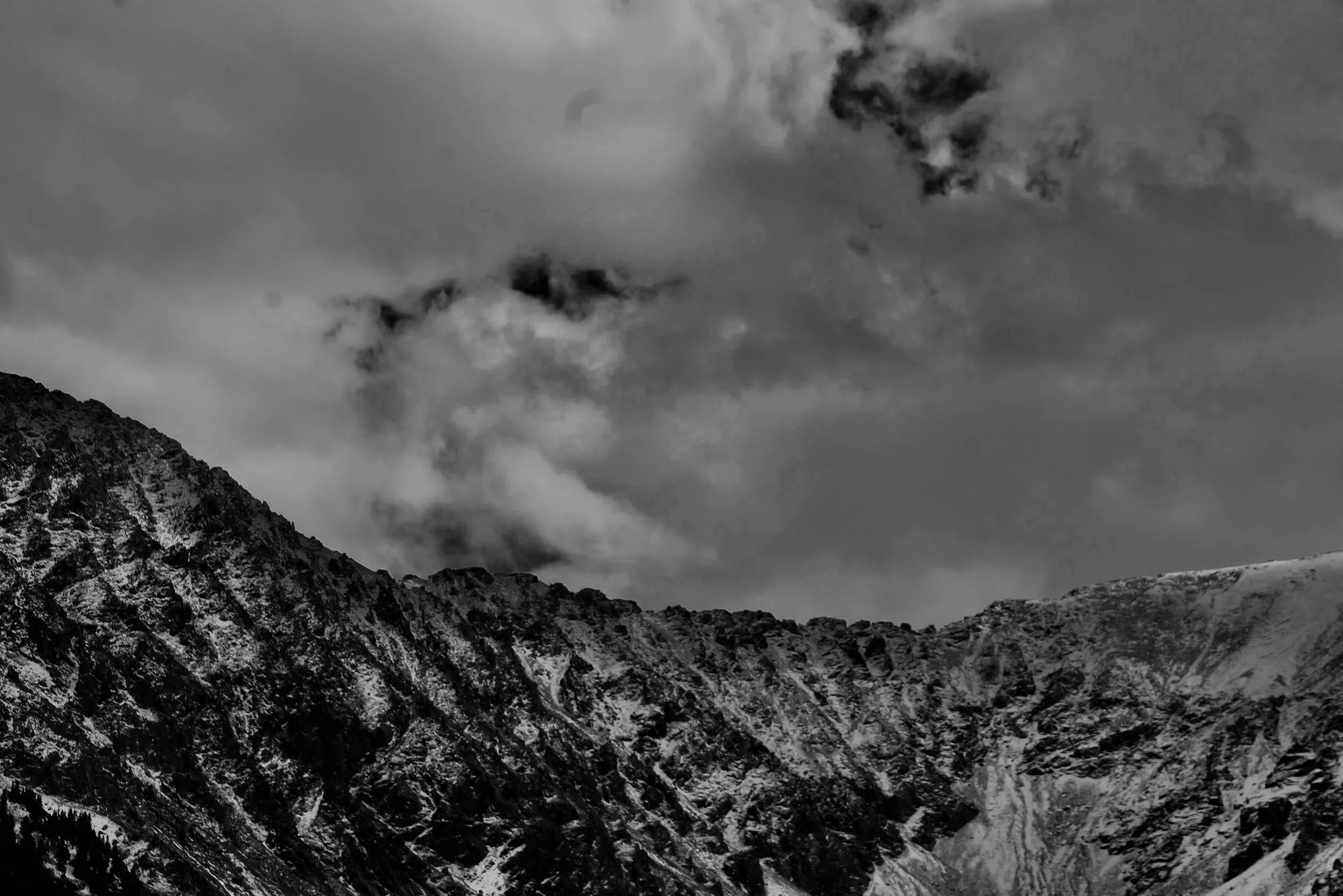 The Obsidian Collectives photo of a colorado mountain top with a storm coming in