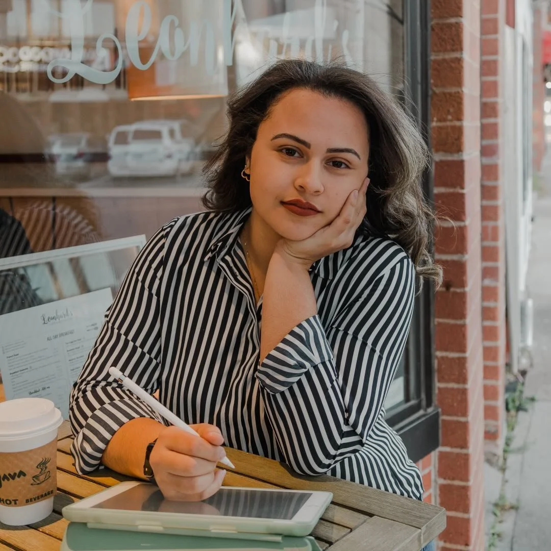 Woman looking towards the camera while drawing on an iPad