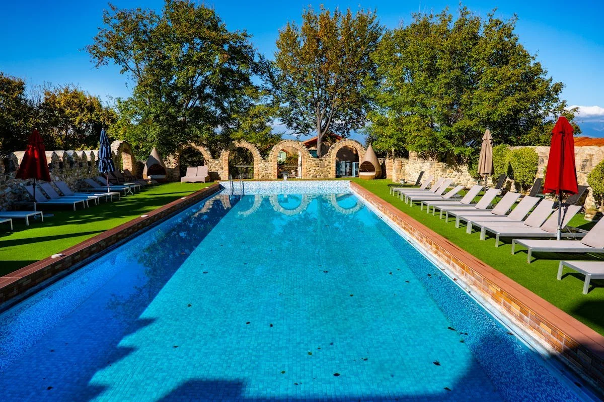 Swimming pool surrounded by lounge chairs and trees. GLO advises on Zoning and Development issues. Contact Geraghty Law Office: Real Estate & Business Law. Trusted Legal Support in Denver, Colorado.