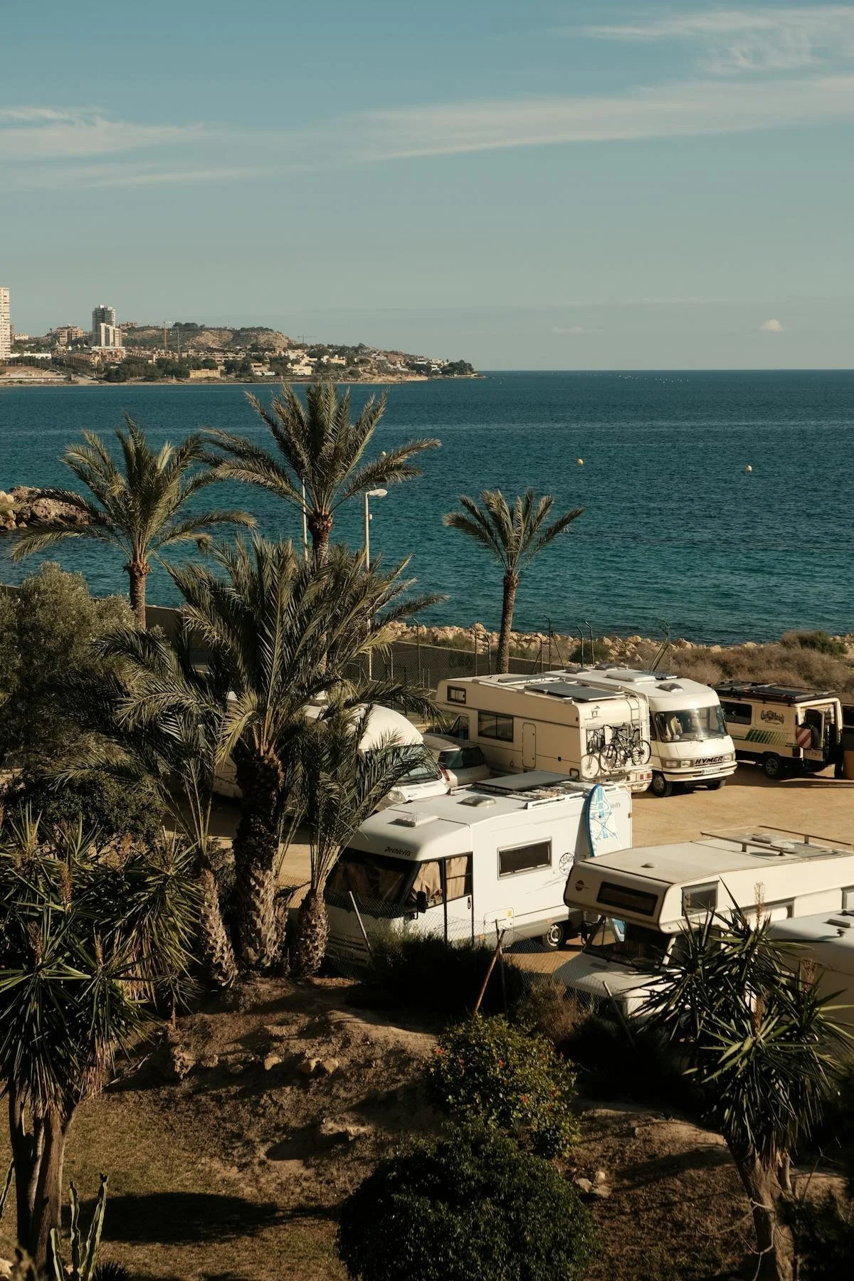 RVs parked by palm trees near ocean during sunset. GLO assists with Mobile Home Park Transactions in Colorado. Contact Geraghty Law Office: Real Estate & Business Law. Trusted Legal Support in Denver, Colorado.