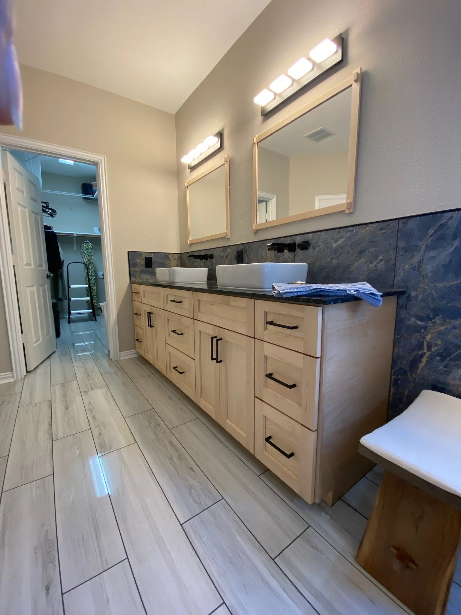 Primary bathroom update with new flooring, updated cabinetry, new stone tile, sink, faucet & lighting installed