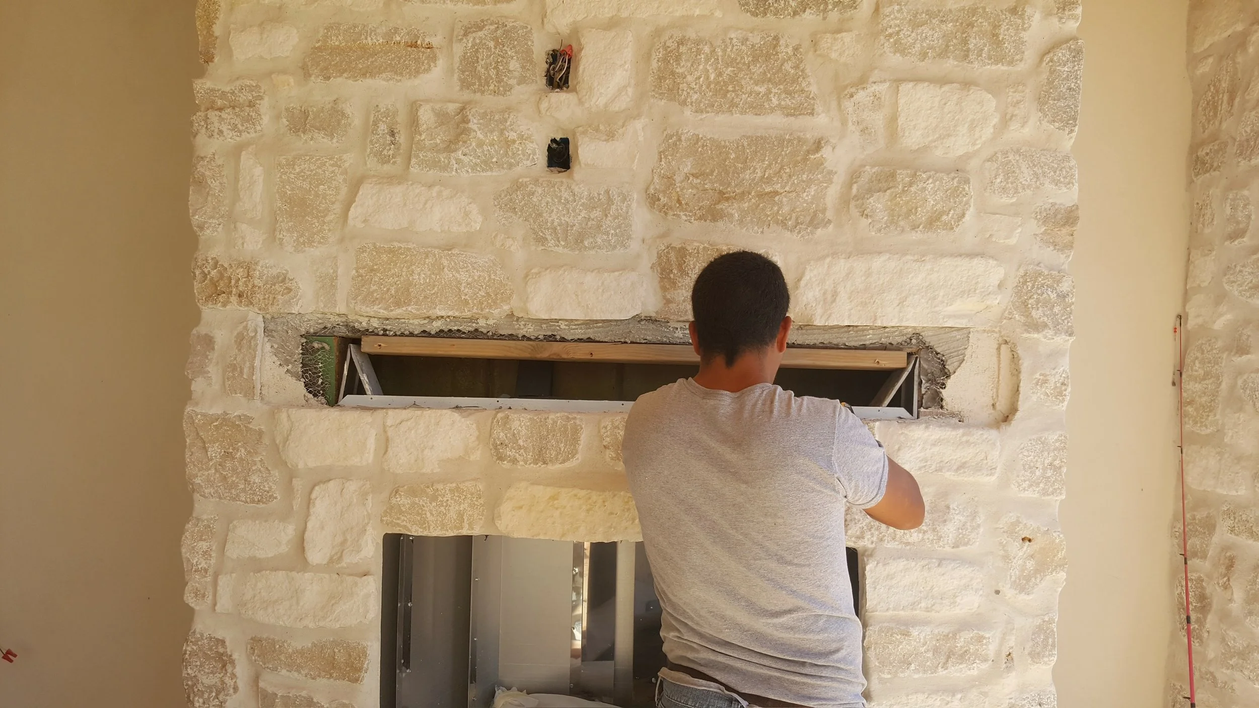 Custom stone fireplace for outdoor living area. Install of wood mantel.