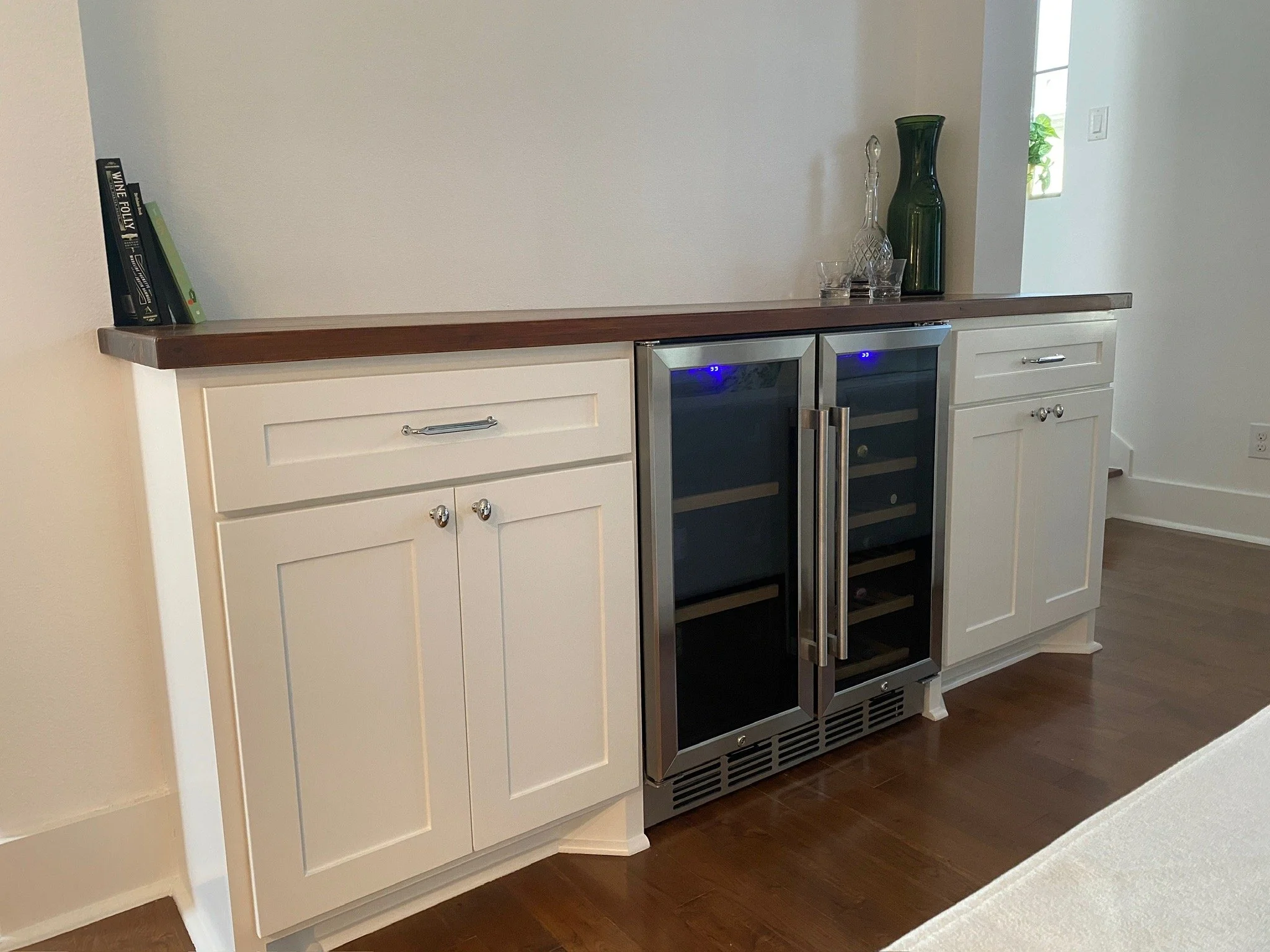 Custom wine fridge & bar cabinetry with wood countertop