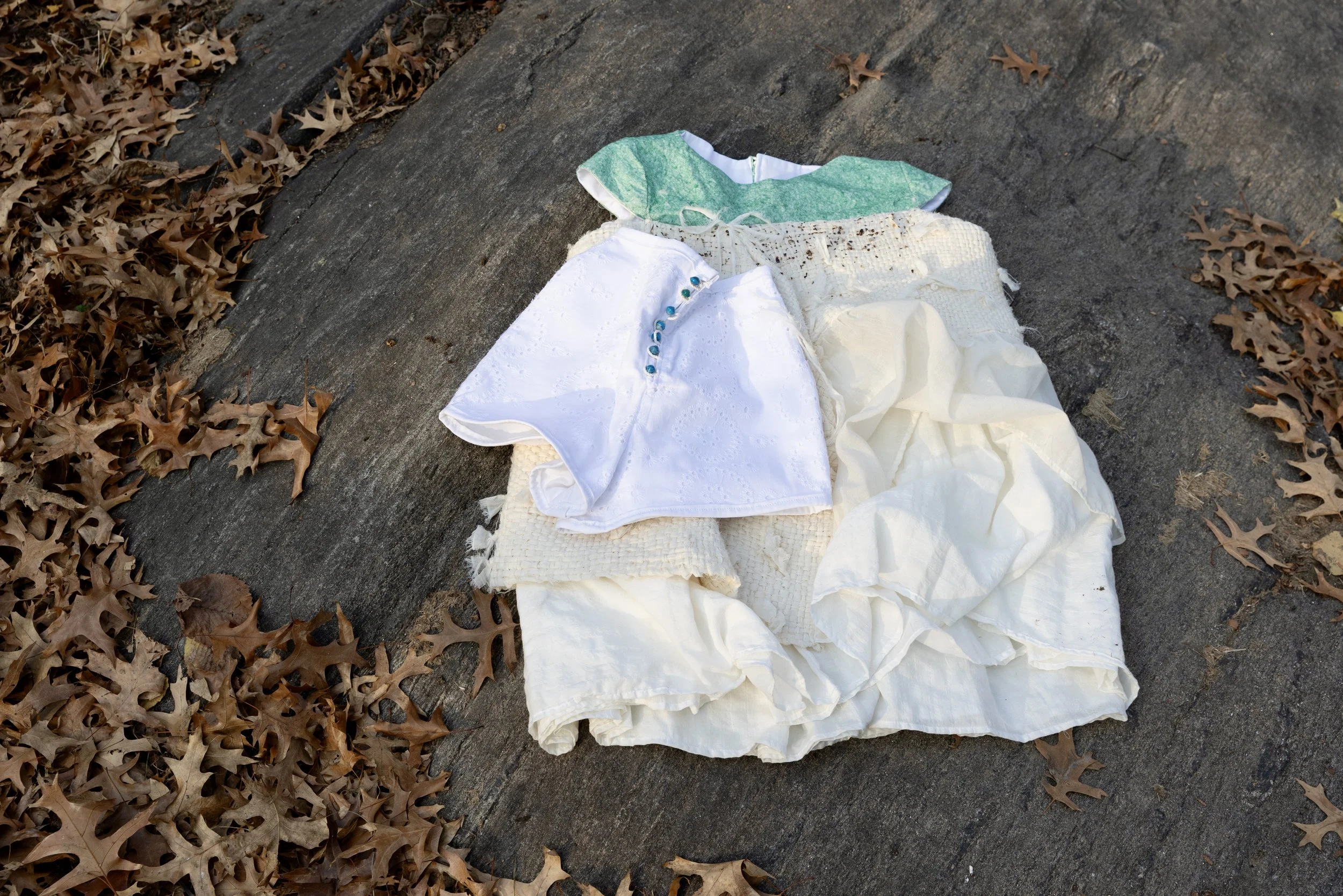 100% biodegradable garments, made of grass mate, biodegradable resin with wildflower seeds, unprocessed cotton, and paper beads.