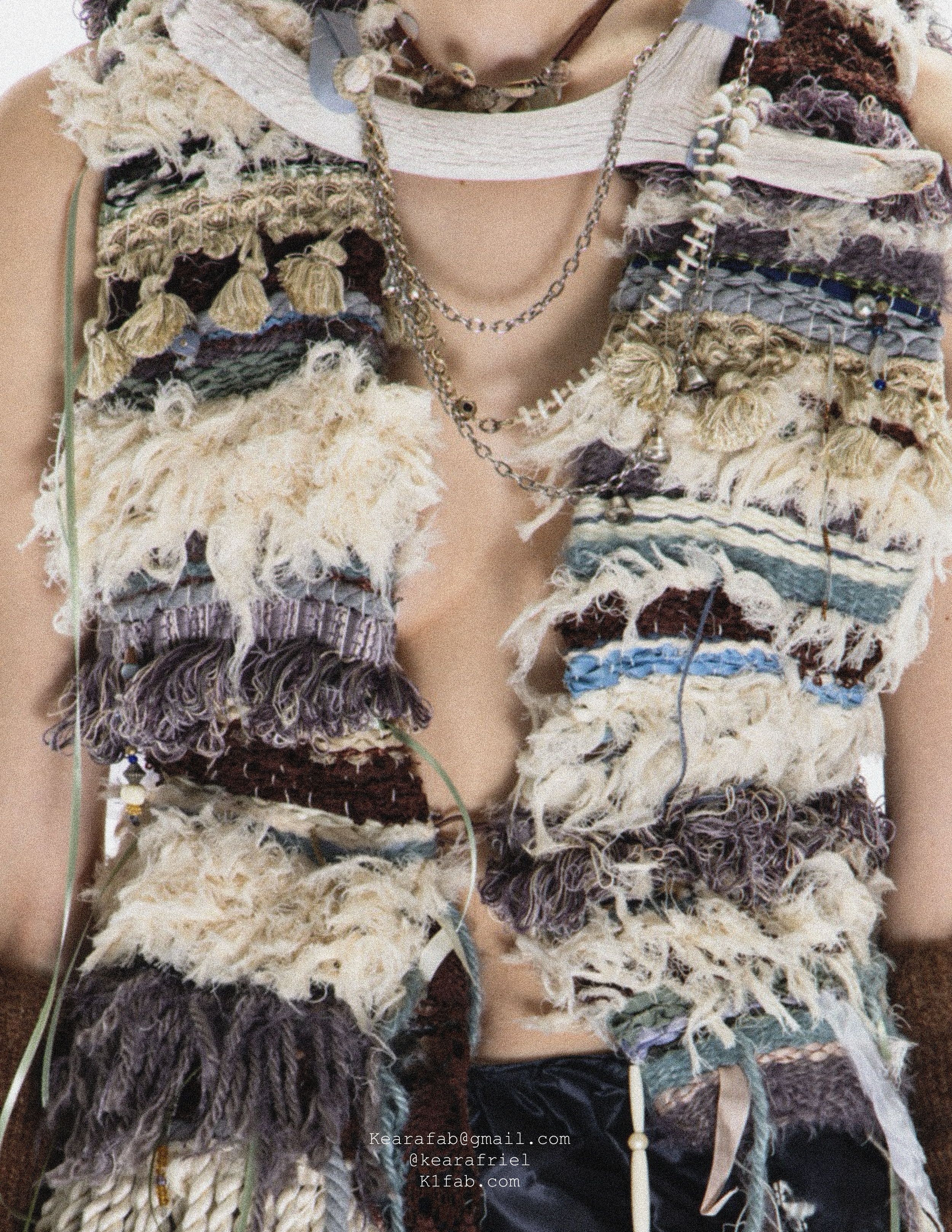 Close up of a hand-woven vest made with all second-hand materials and found objects.