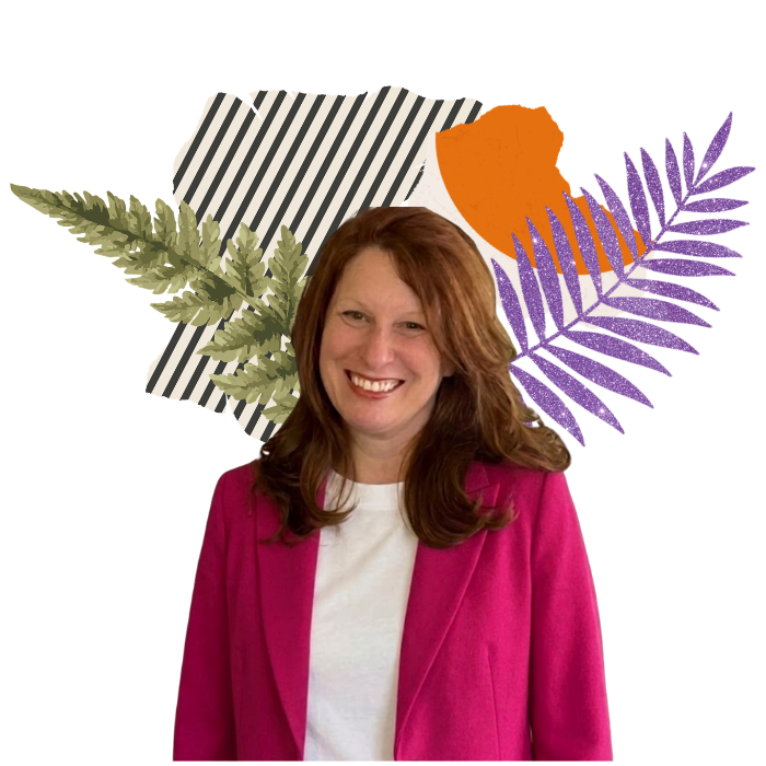 A smiling woman with red hair wearing a pink blazer and white shirt, standing in front of a colorful collage of tropical leaves and abstract patterns.