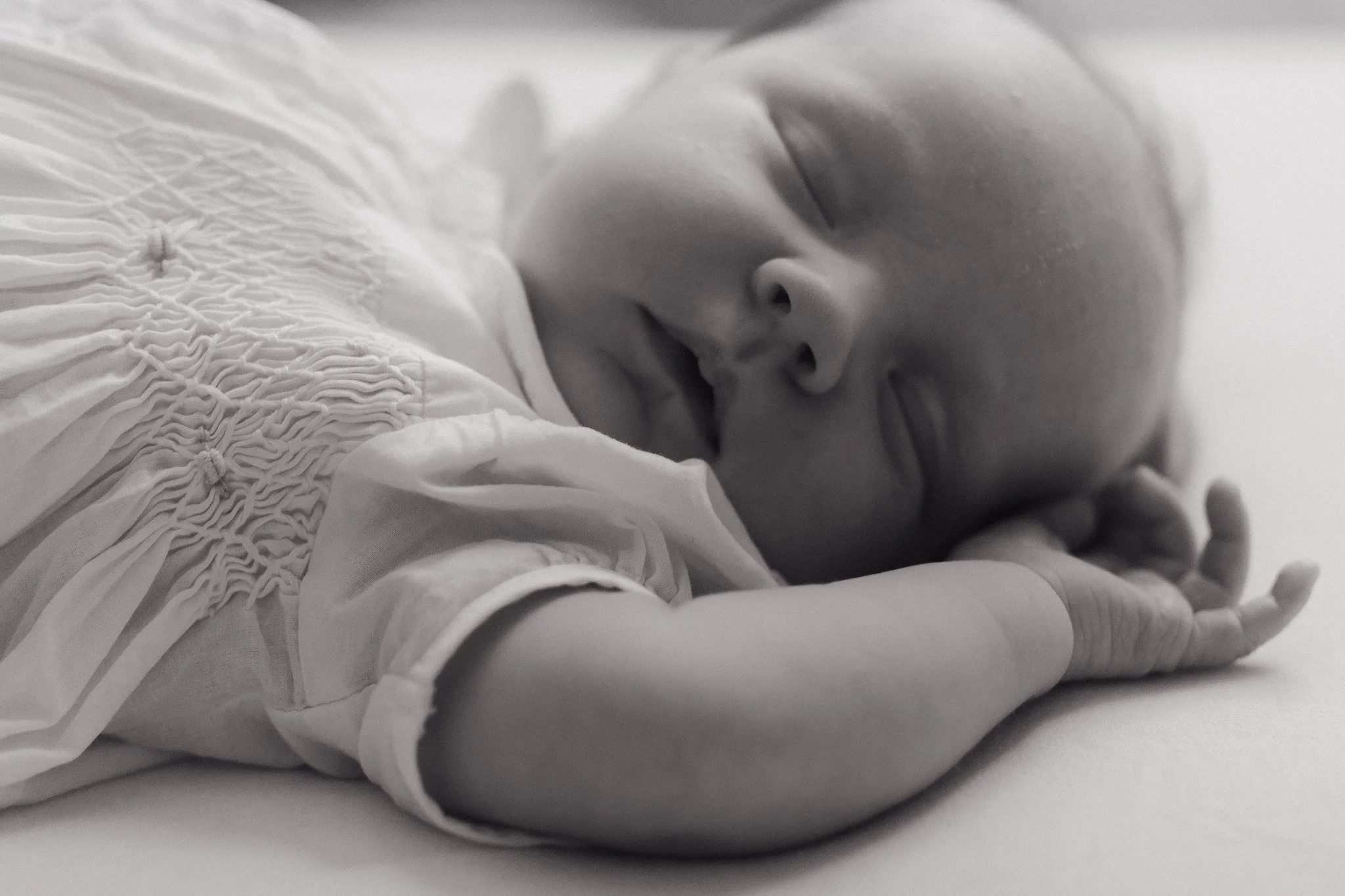 Close-up of a sleeping baby with a blanket, in black and white in Memphis, TN. 