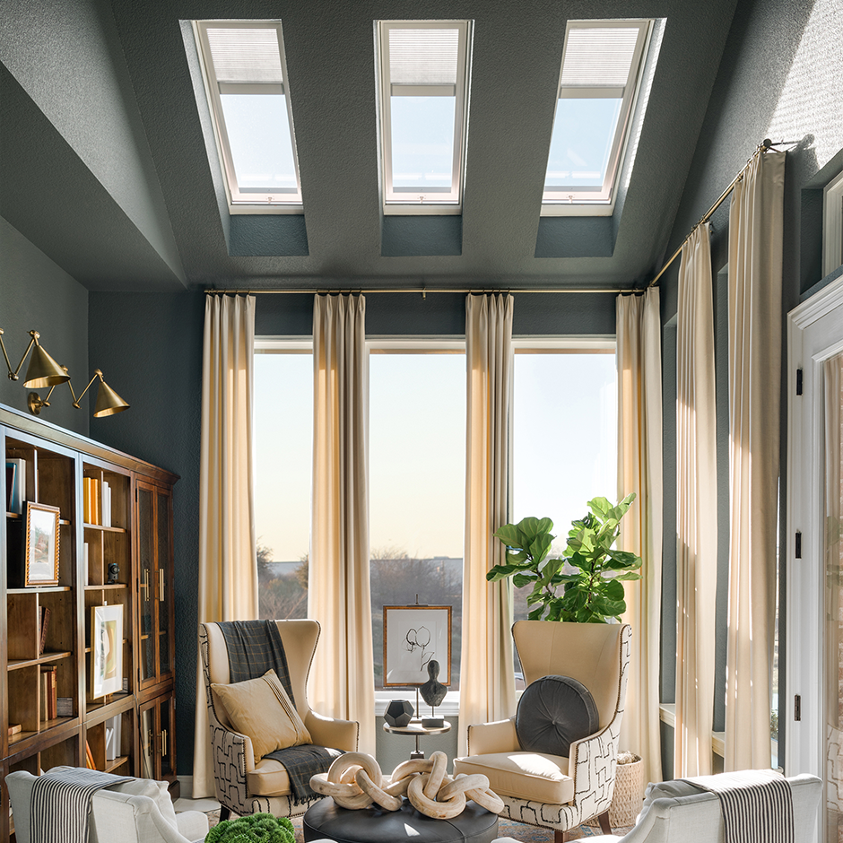 Living room with vented skylights and shades.