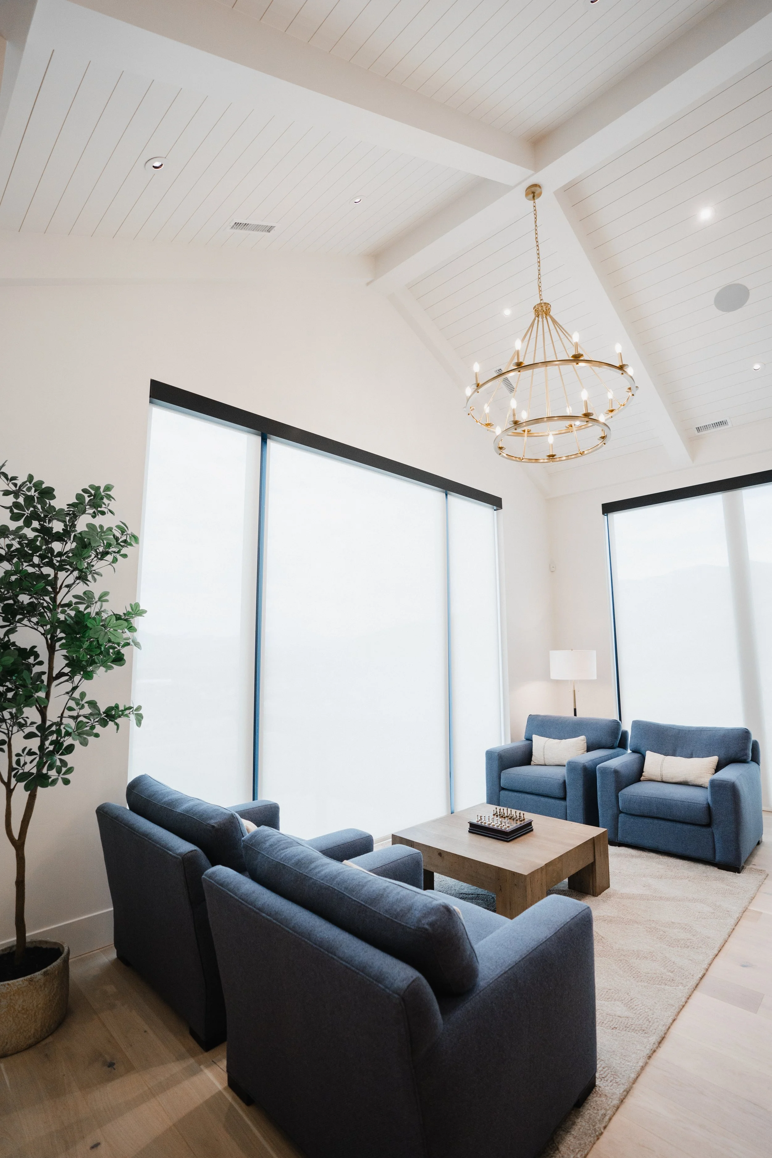 Tall living room with blue sofas in Utah.
