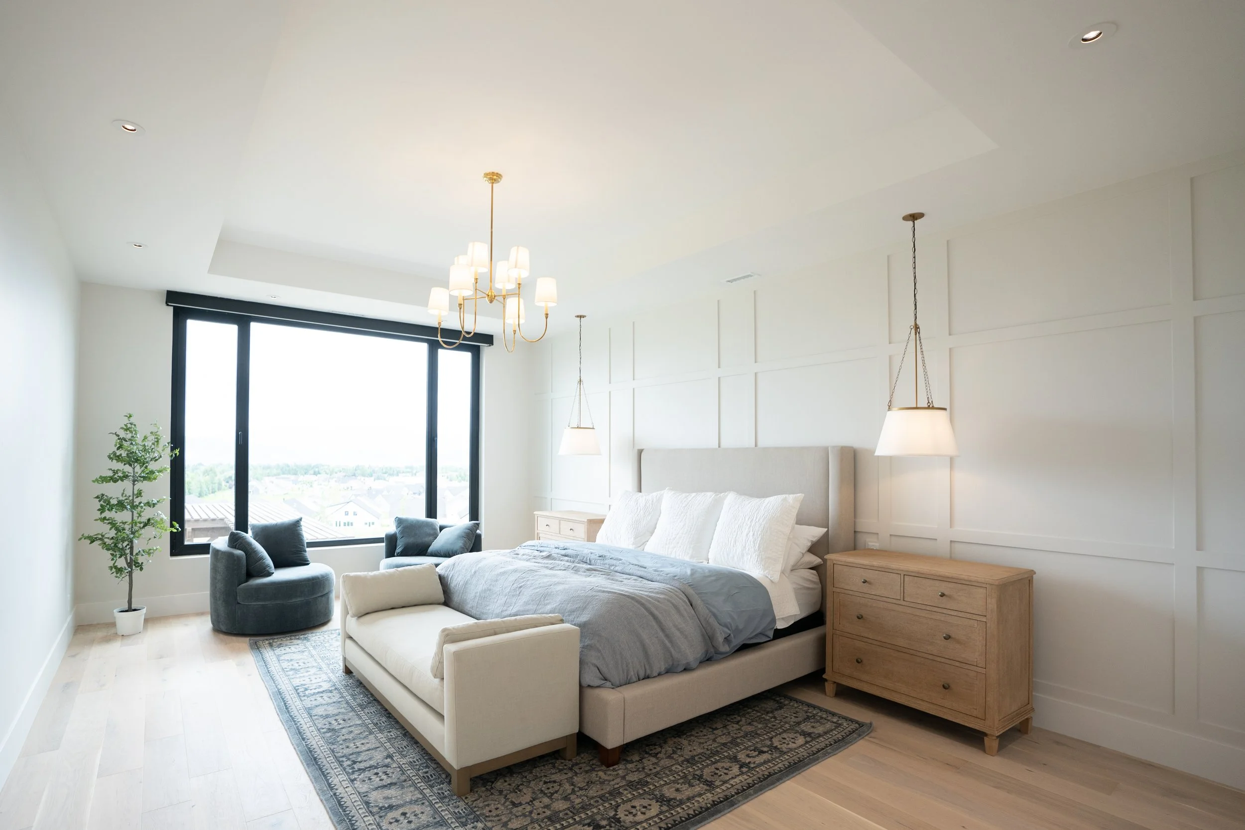 Modern bedroom with a large window as part of a house in Utah being sold by a real estate agent