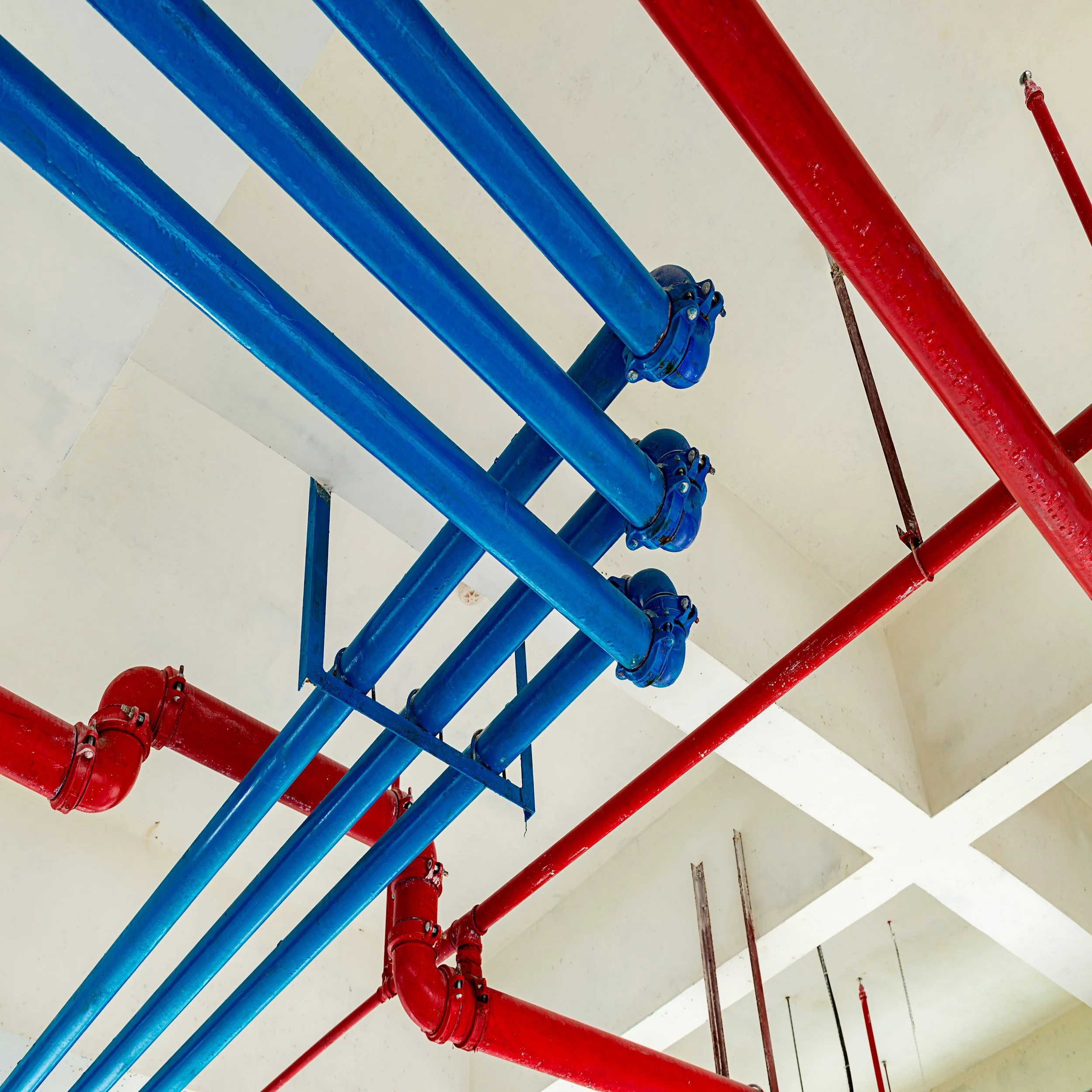 Blue and red water pipes installed on the ceiling.