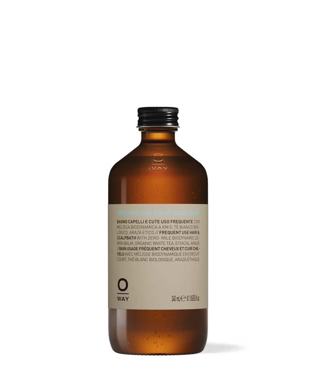 Brown glass bottle of frequent use hair and scalp bath with a black screw cap and light-colored label.