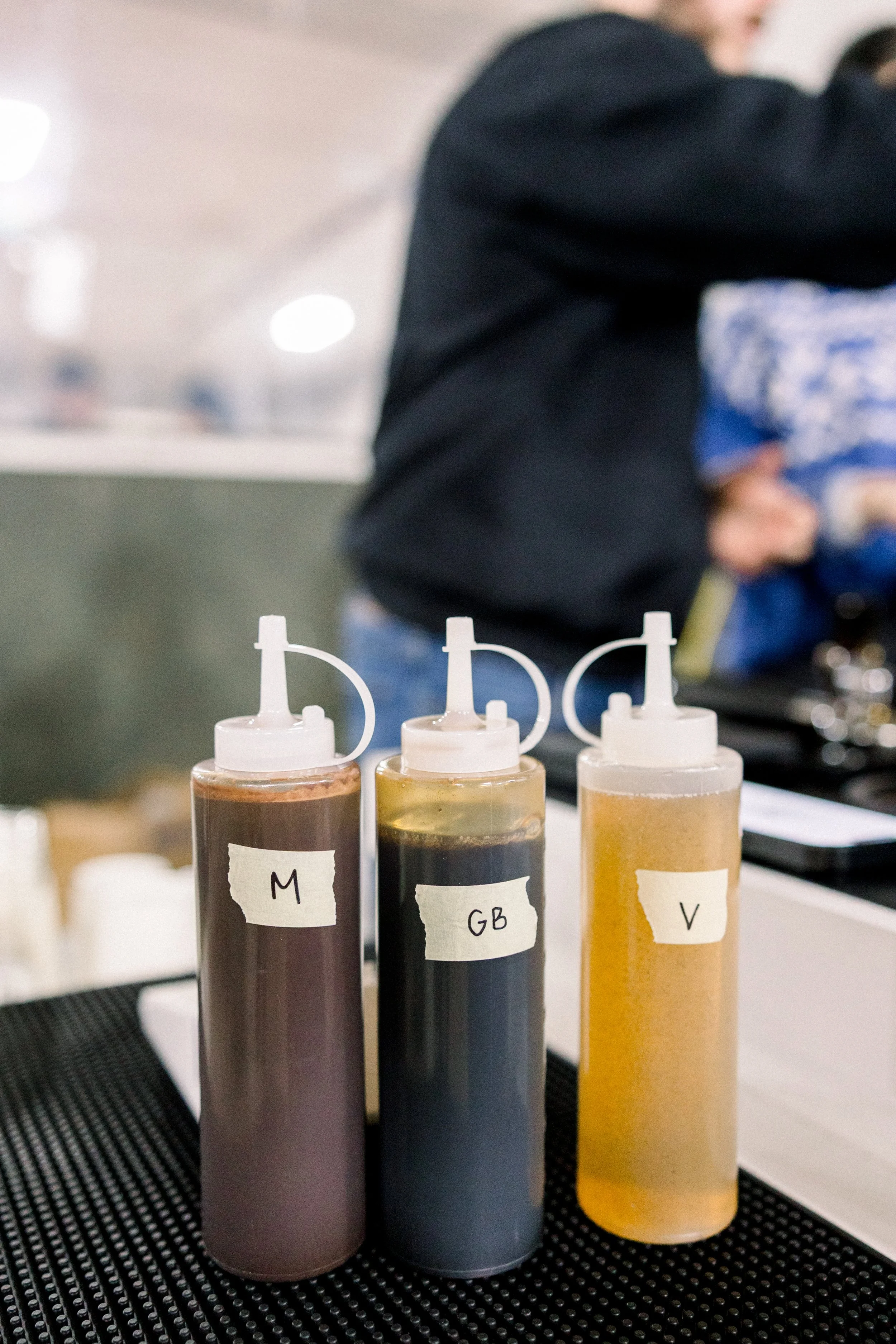 Coffee cart catering with homemade syrups. Mobile barista with homemade coffee syrups. Vanilla syrup, gingerbread syrup, mocha syrup. Homemade cocoa. Coffee syrups on a mobile espresso bar for coffee catering service.