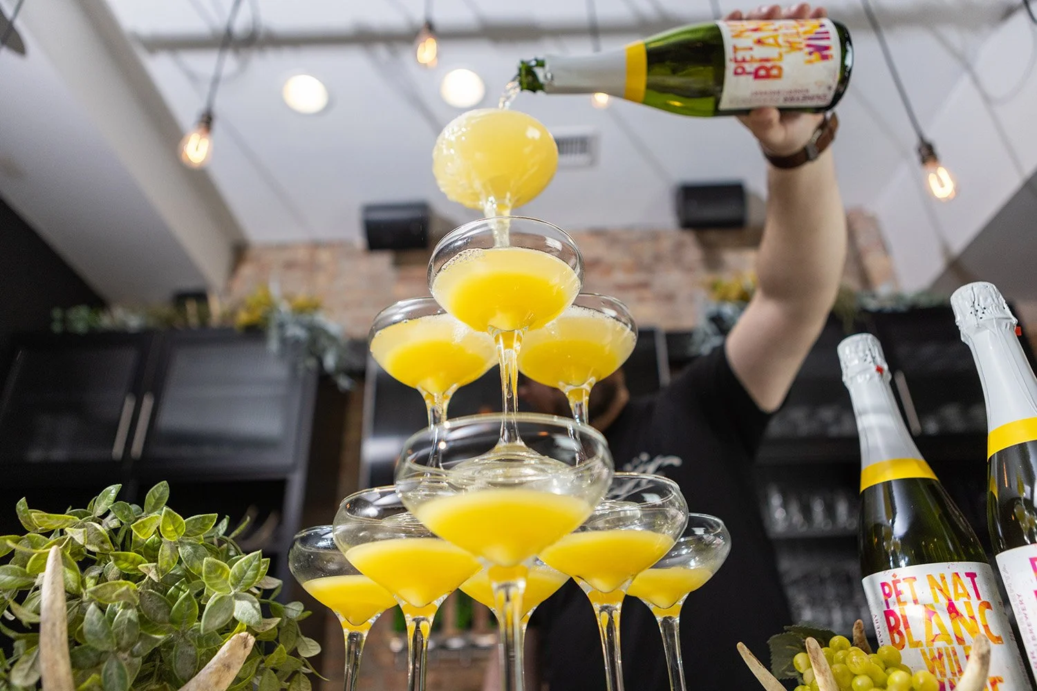 bartender pours mimosas at Tethered Events in Chicago