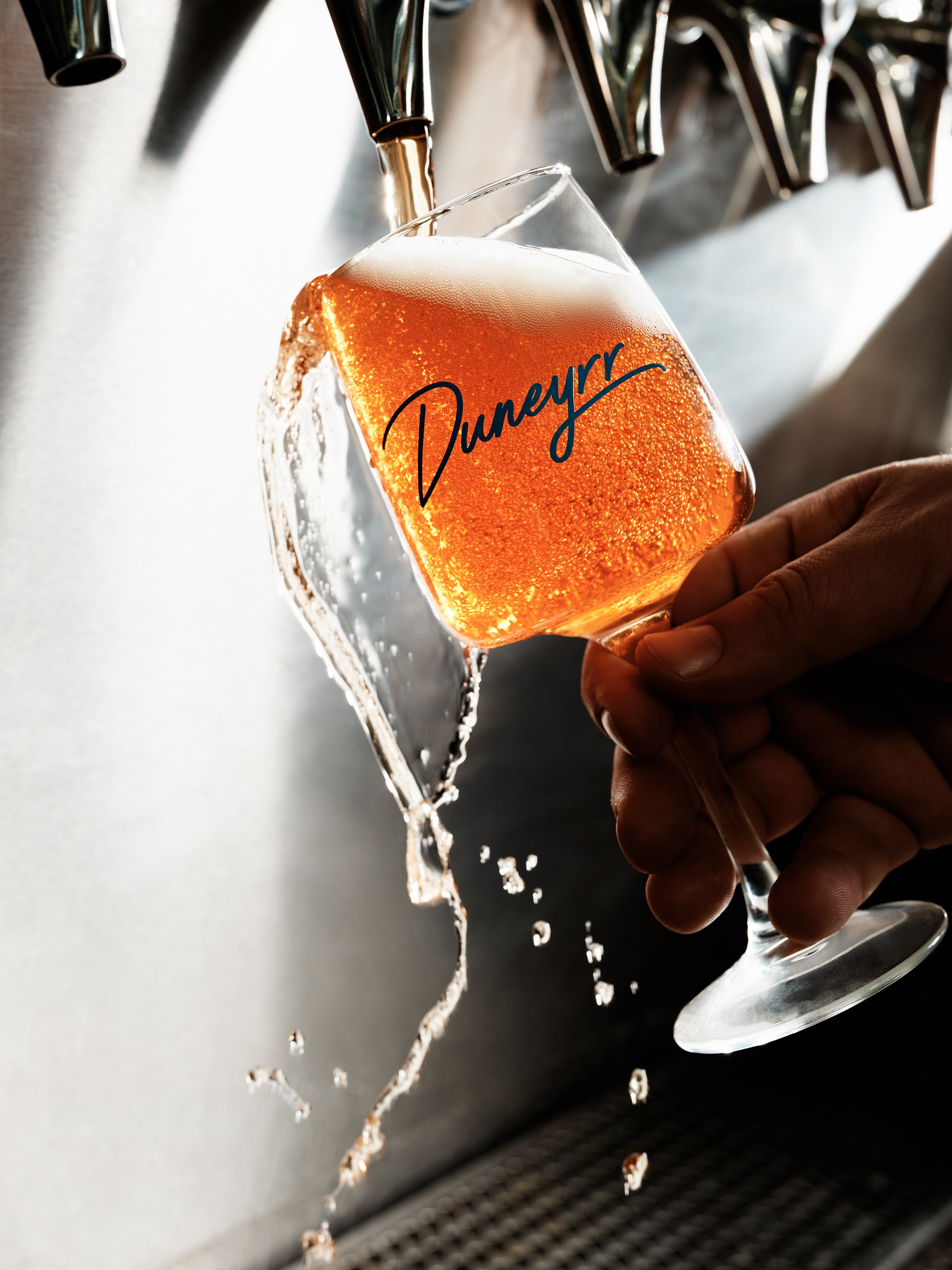 Beer being poured into a beer glass from taps at Tethered Events
