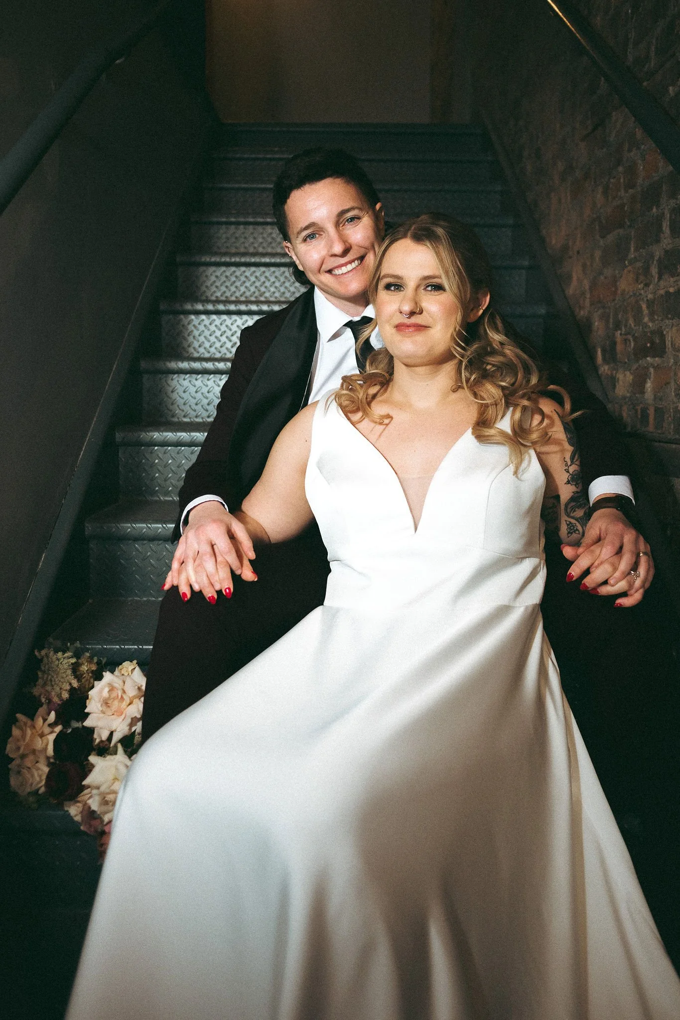 couple poses in the staircase at Tethered Events in South Loop, Chicago