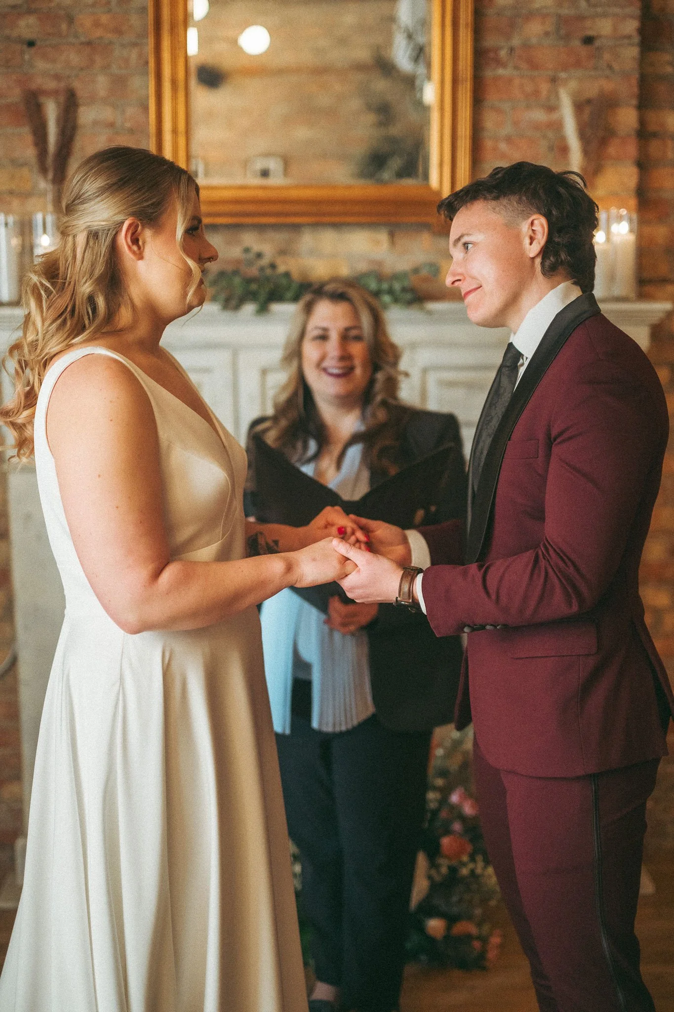 couple performs wedding ceremony in front of fireplace at Tethered Events in South Loop Chicago