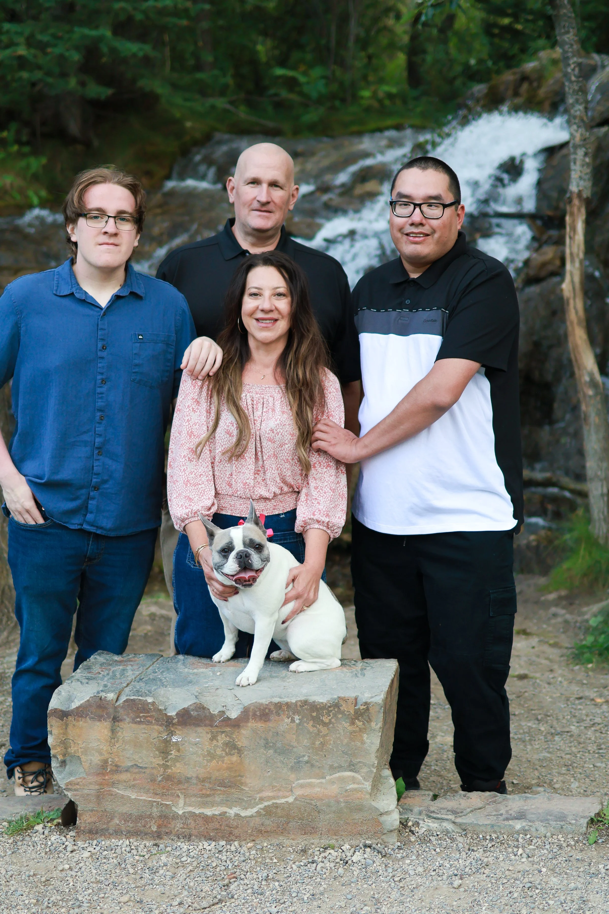 Family photo taken by the waterfall at Big Hill Springs