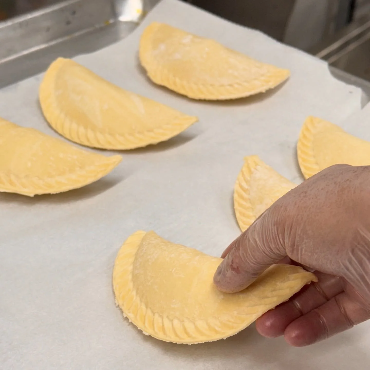 There&rsquo;s an art to making empanadas &mdash; and we love every step of it. 🥟💛
Freshly folded, baked golden, and filled with pure Spanish flavor.
We sold out last weekend, so this time&hellip; come hungry and early!

#Empanadas #TapeoPaella #Pho