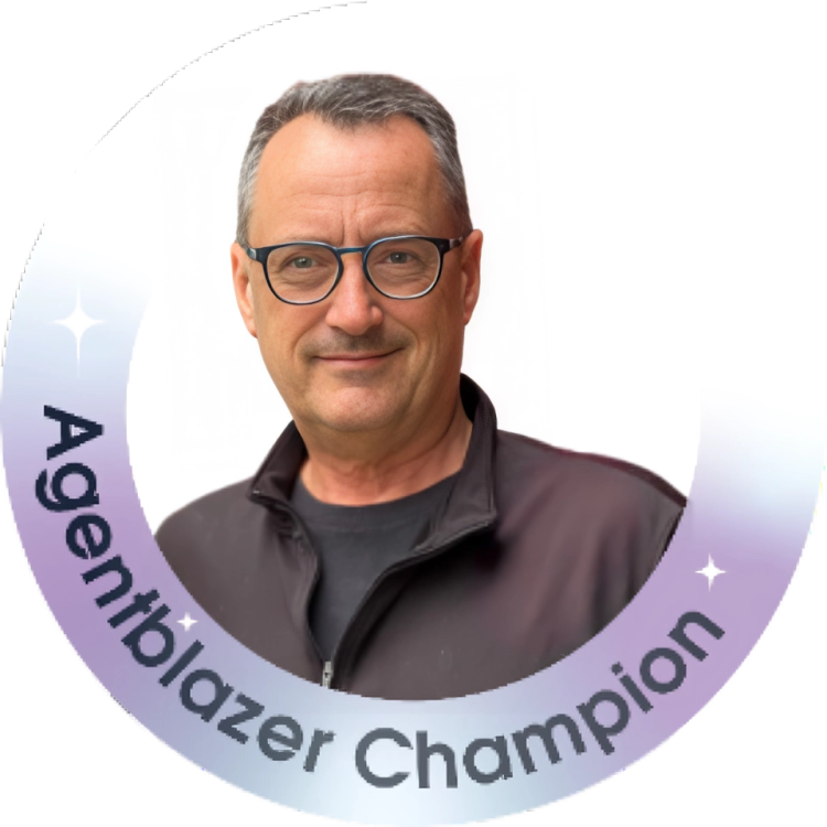 A middle-aged man with gray hair and glasses, wearing a black jacket, smiling. Text around the image reads 'Agile Partner Champion'.