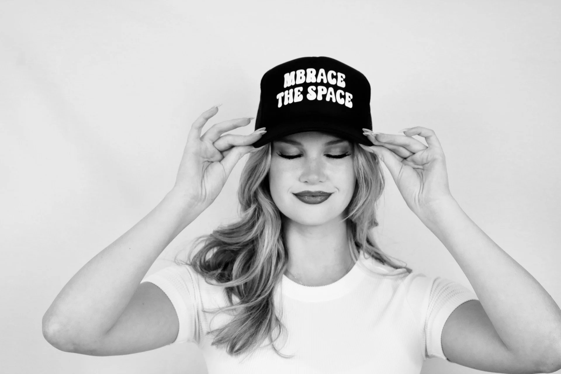 Founder of MBrace the Space, LLC wearing a cap that says "MBrace the Space".