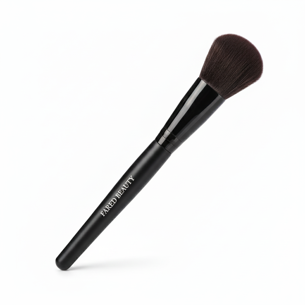 Black makeup brush with brown bristles and the words "FARED BEAUTY" written on the handle, isolated on a white background.
